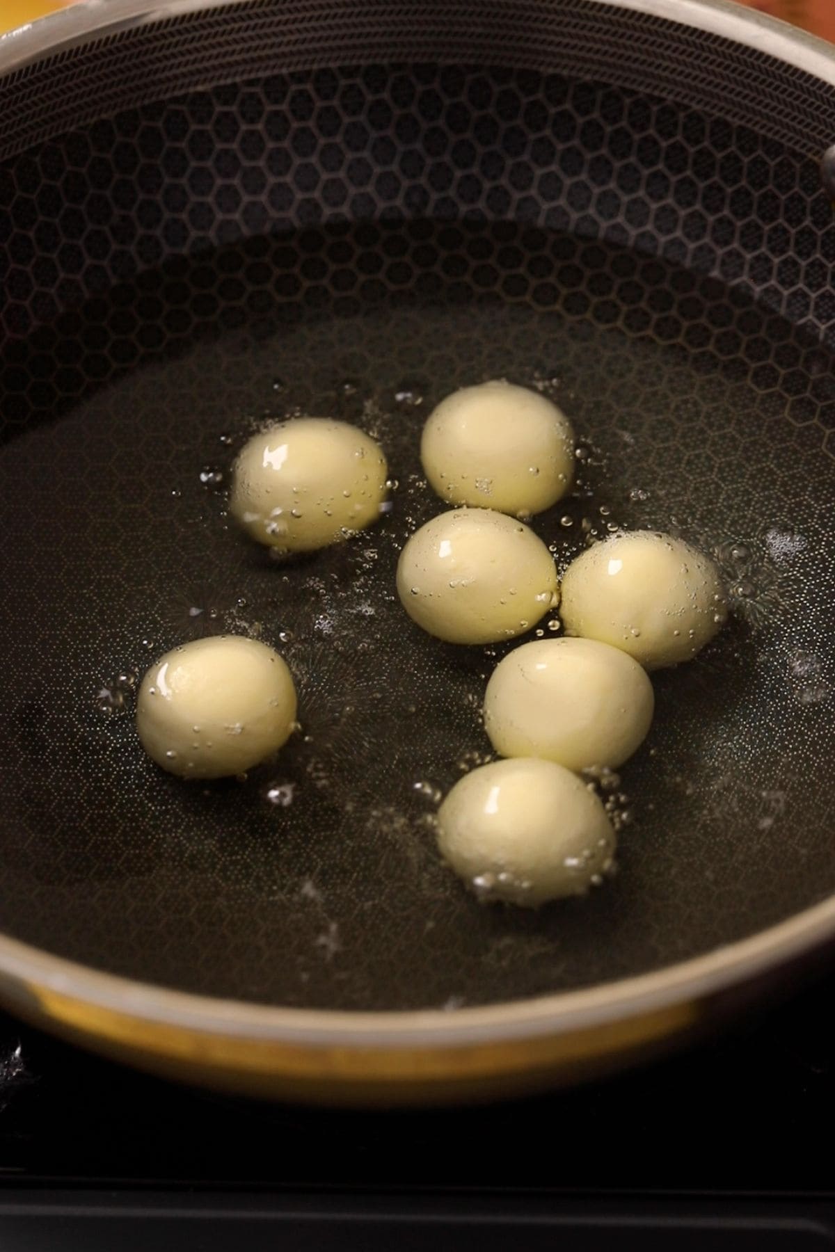 Dough balls are placed in hot oil.