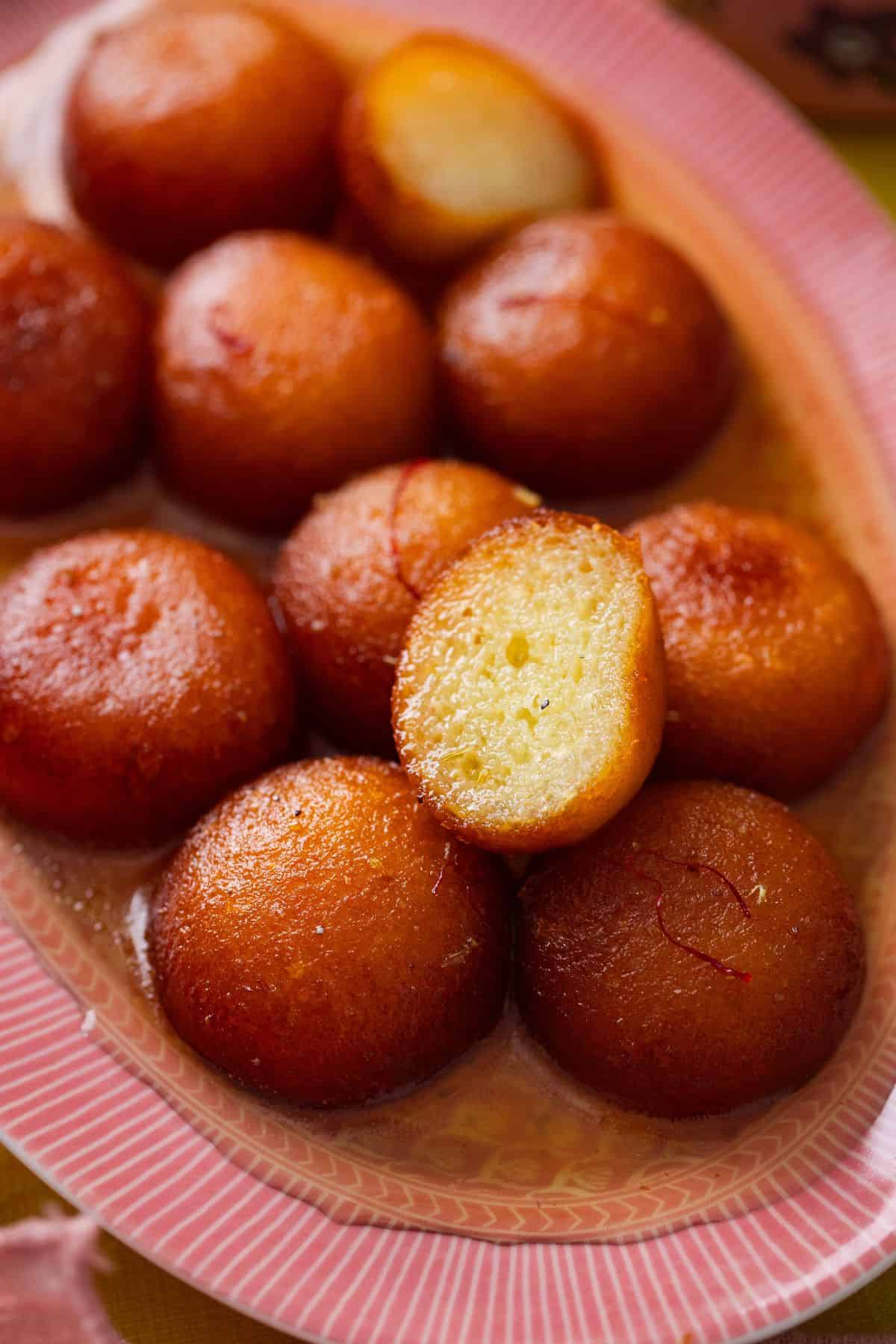 IMG_0479-1 Closeup of gulab jamun cut open to show the spongy syrup filled inside.