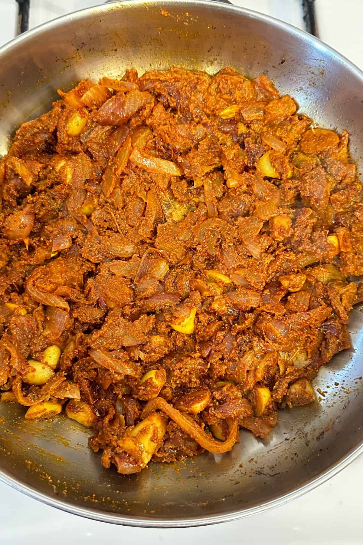 Spice powders are mixed and toasted with onions.