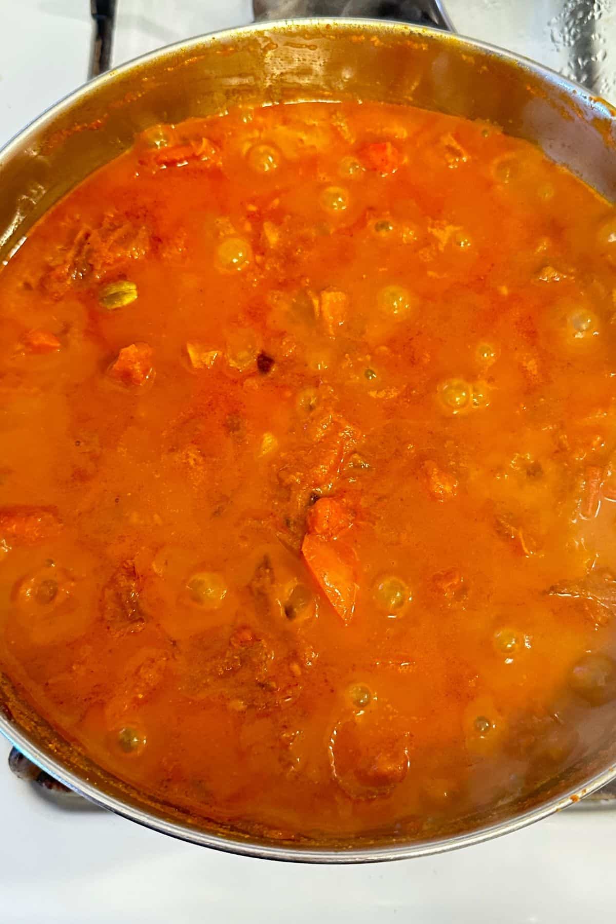 Cooking pot is covered and the masala is cooked until everything is soft.