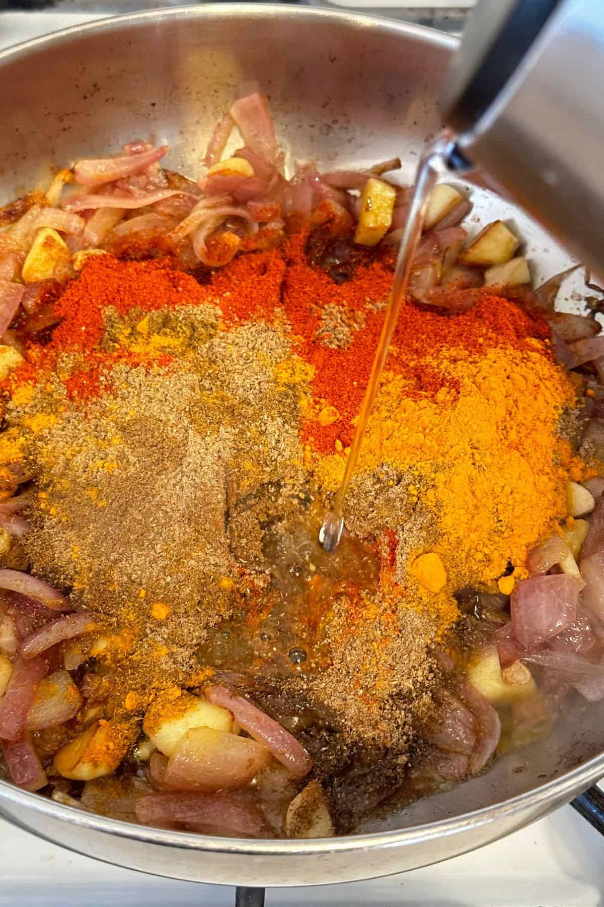 Spice powders and bit of water is added to the browned onions.