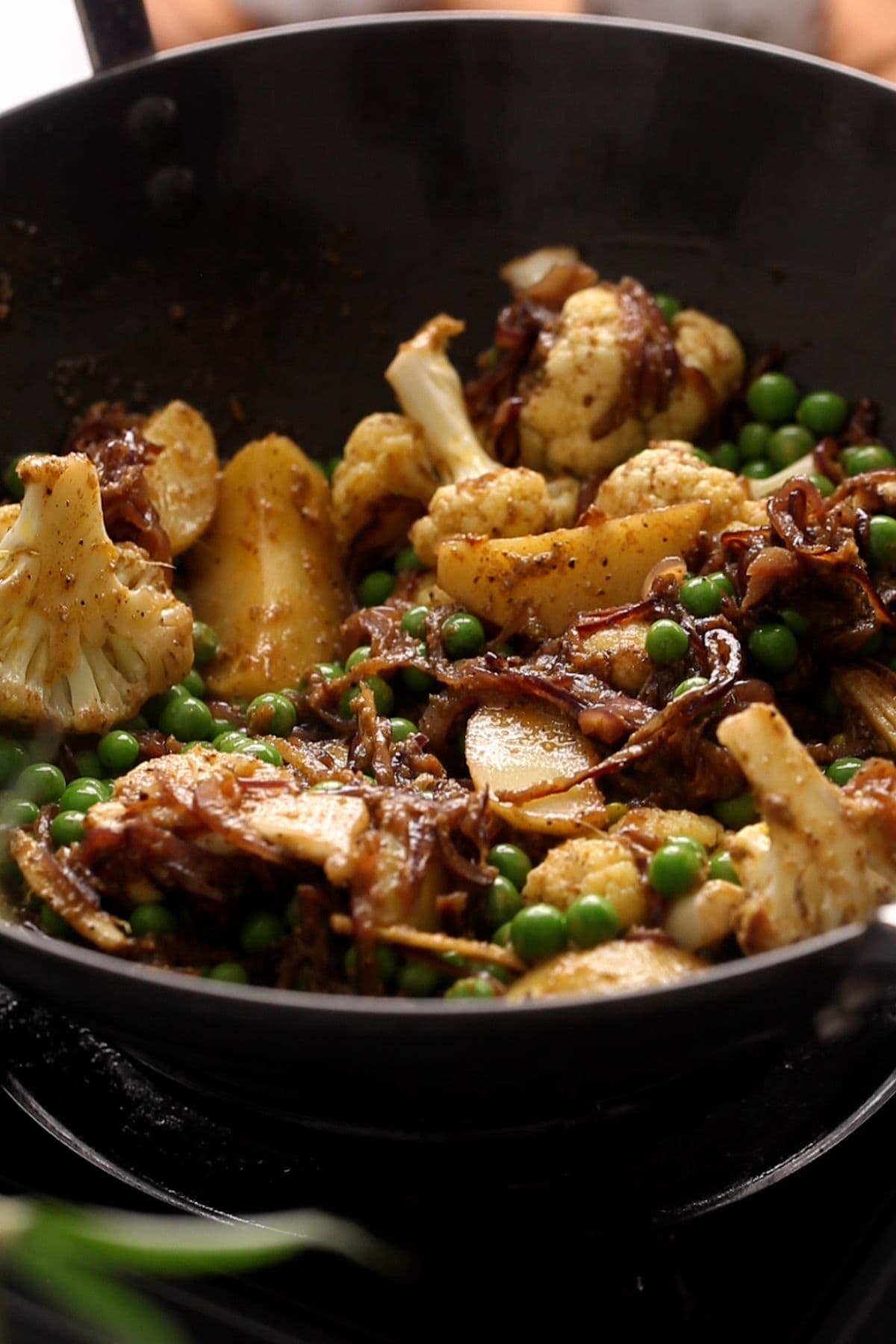 Vegetables are coated and fried with the ground masala. 