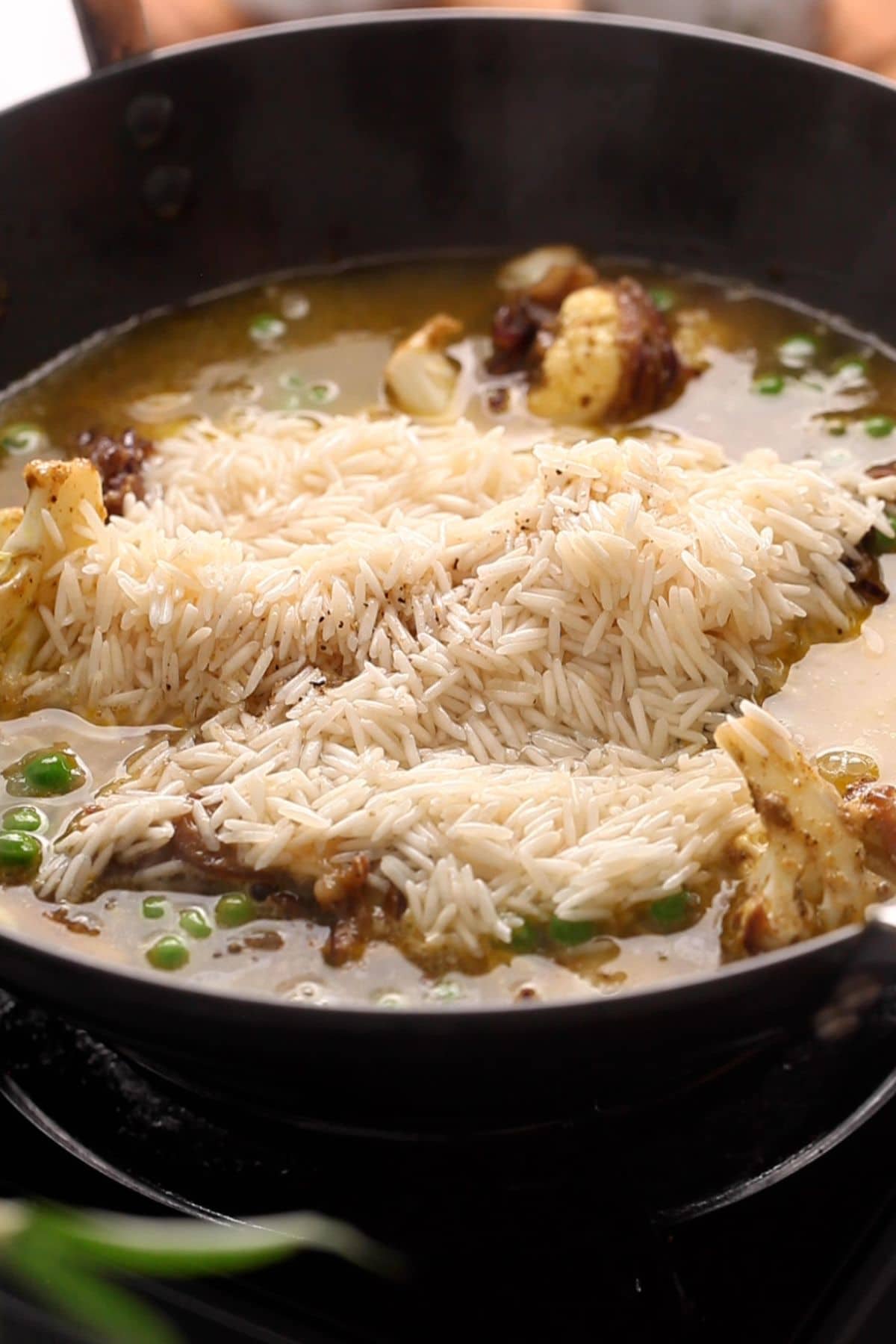 Basmati rice and water is adde to the vegetables. 