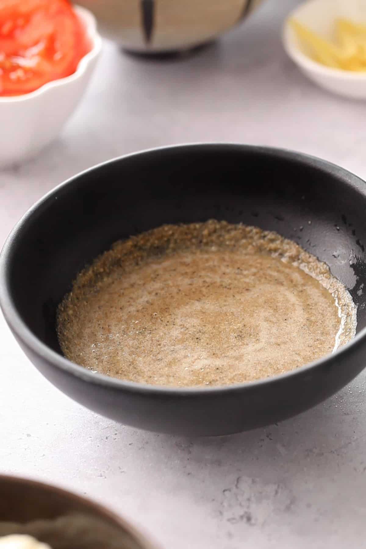 Homemade spice paste in a black bowl.