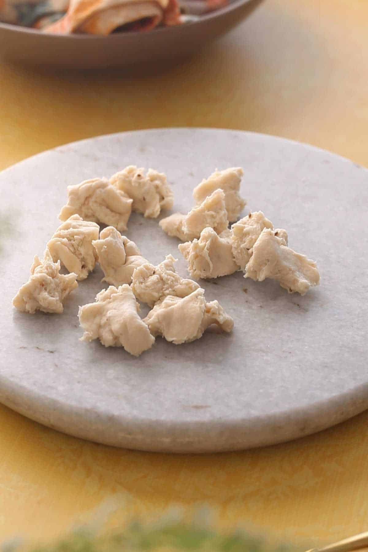 Dough portions on a marble rolling surface.