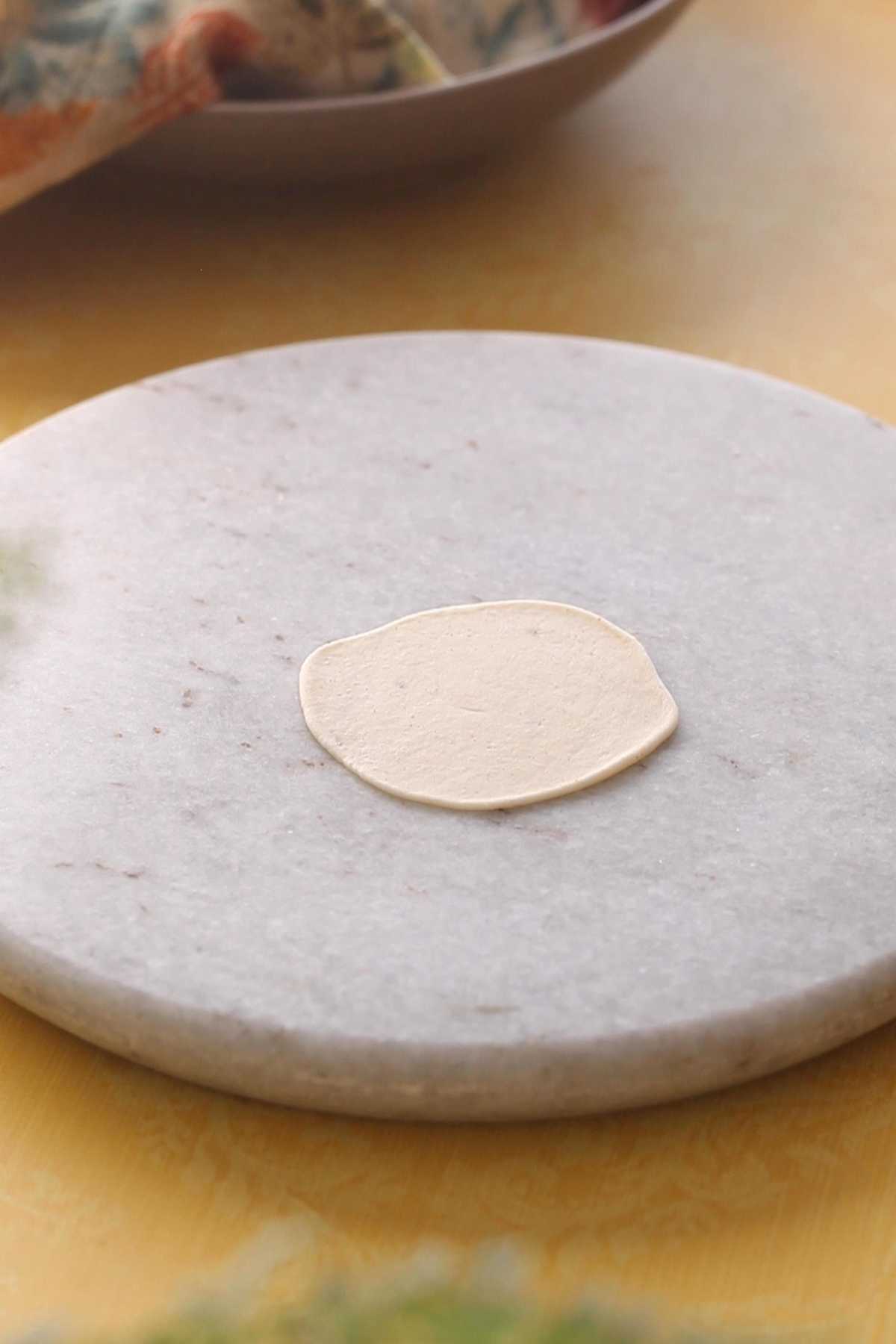 Rolled papdi on a marble board.