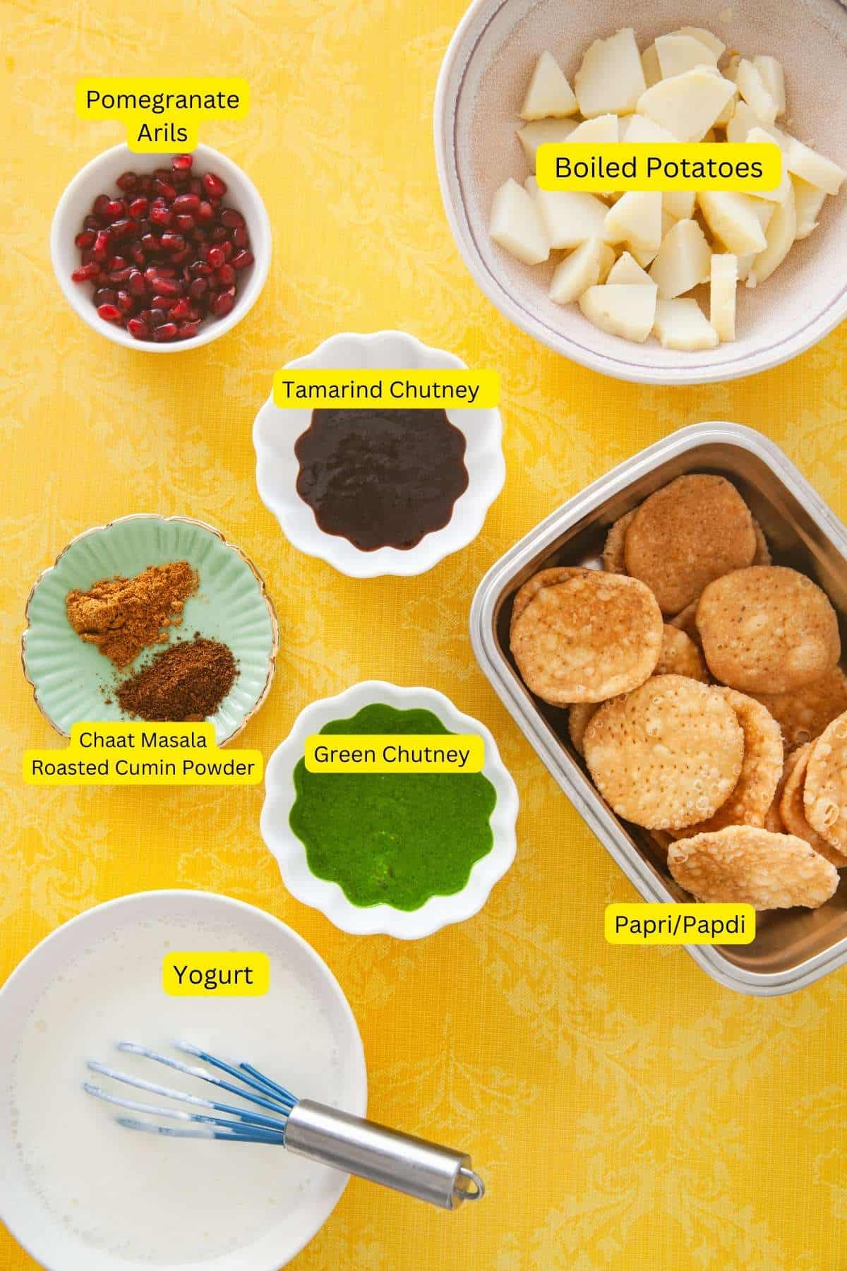 Ingredients for papri chaat on a yellow background.