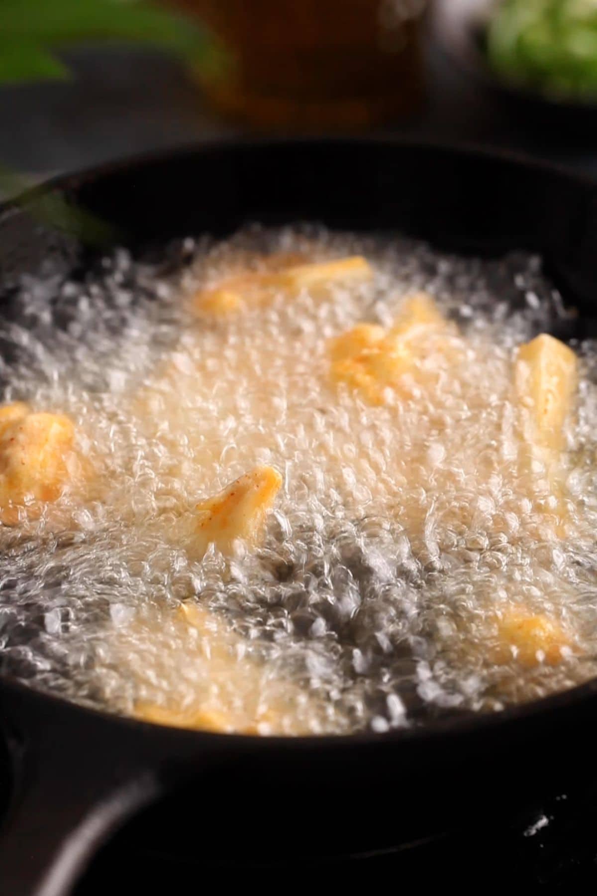 Deep frying cauliflower florts in hot oil.