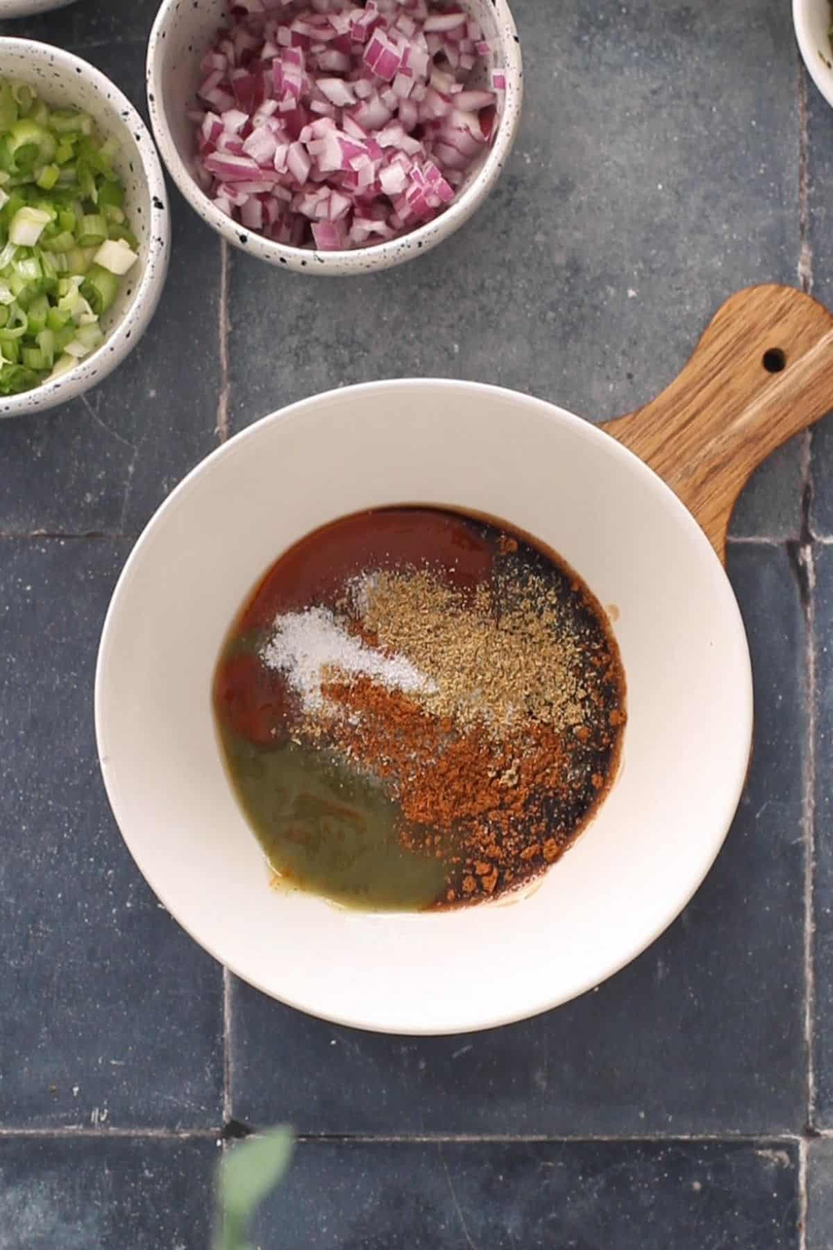 Mixing condiments and spices for manchurian sauce.