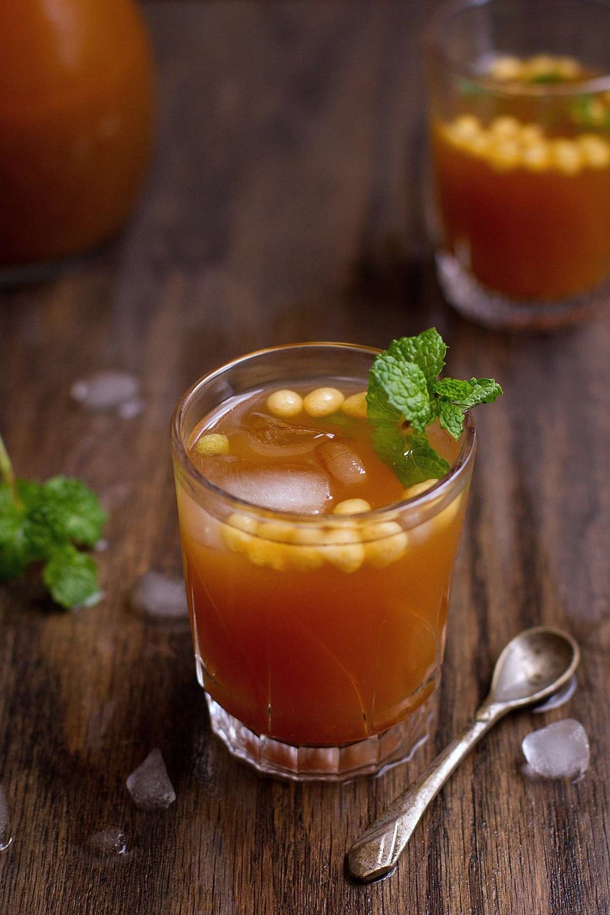 Indian Cumin Cooler served in a shot glass with ice cubes and boondi. 