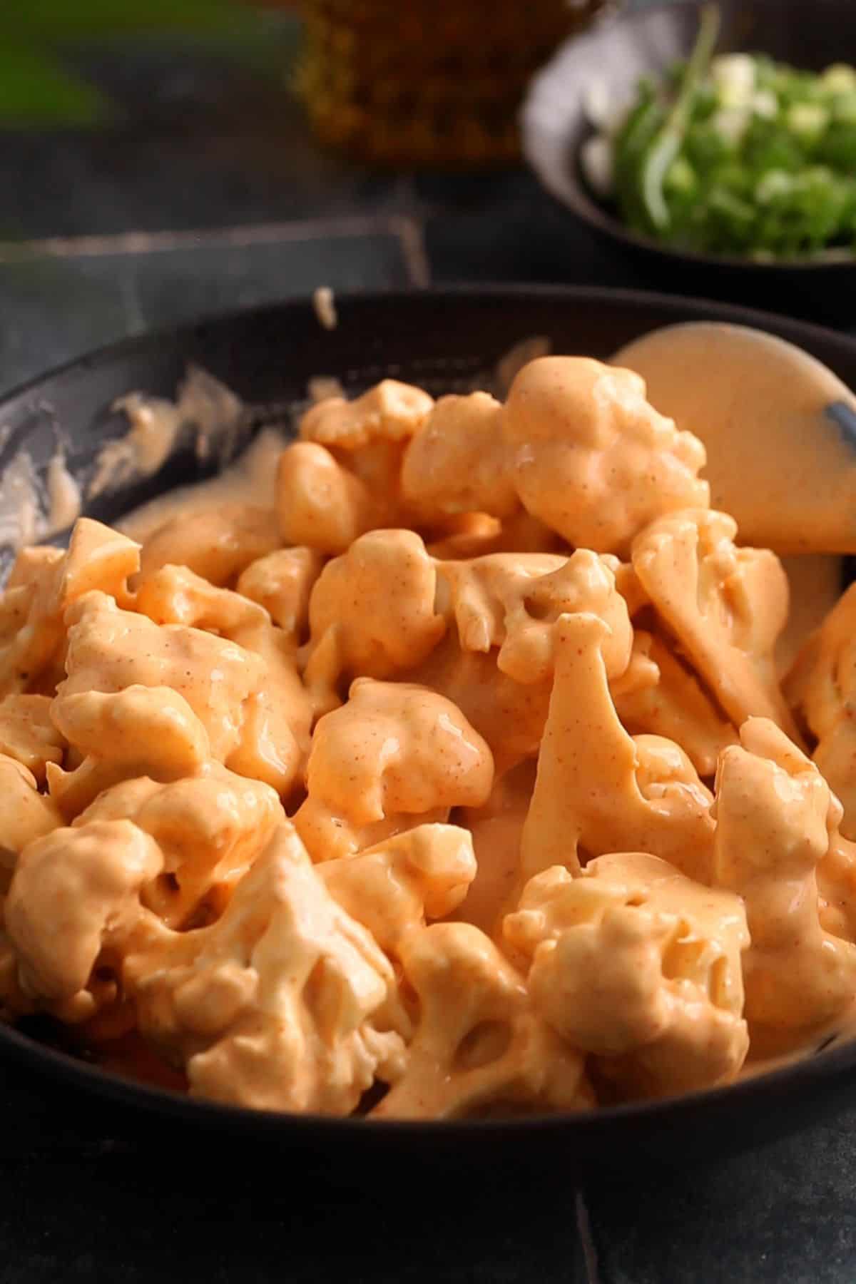 Toss the florets to coat well in batter.