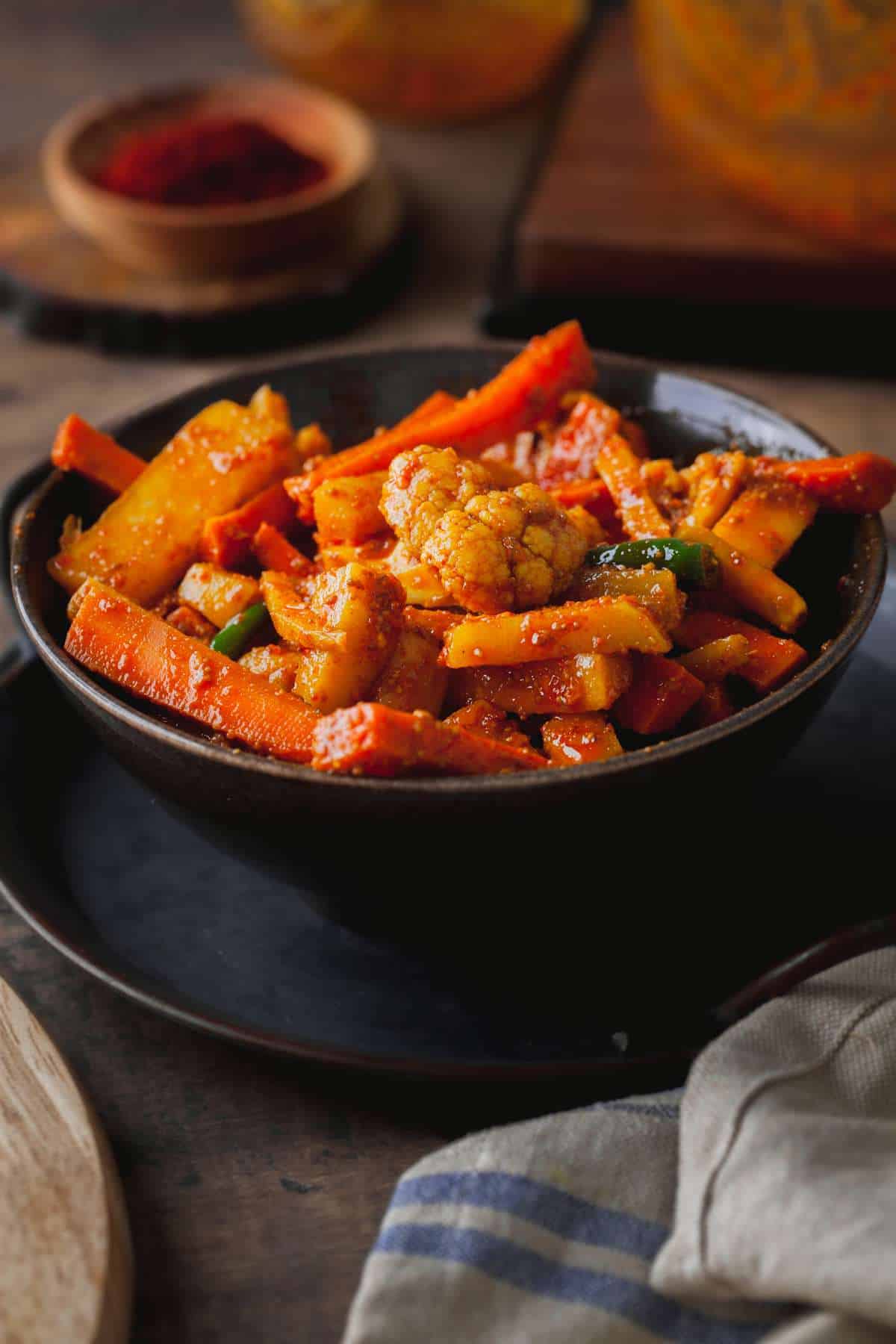 Close up of Gajar Gobhi Achar in a Black bowl.