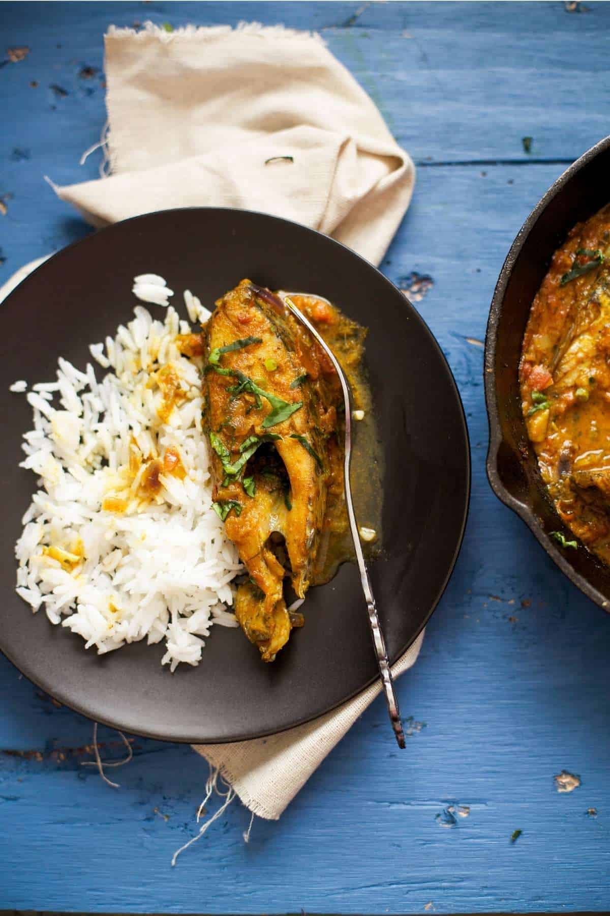 North Indian Fish Curry With steamed rice on a blue background. 