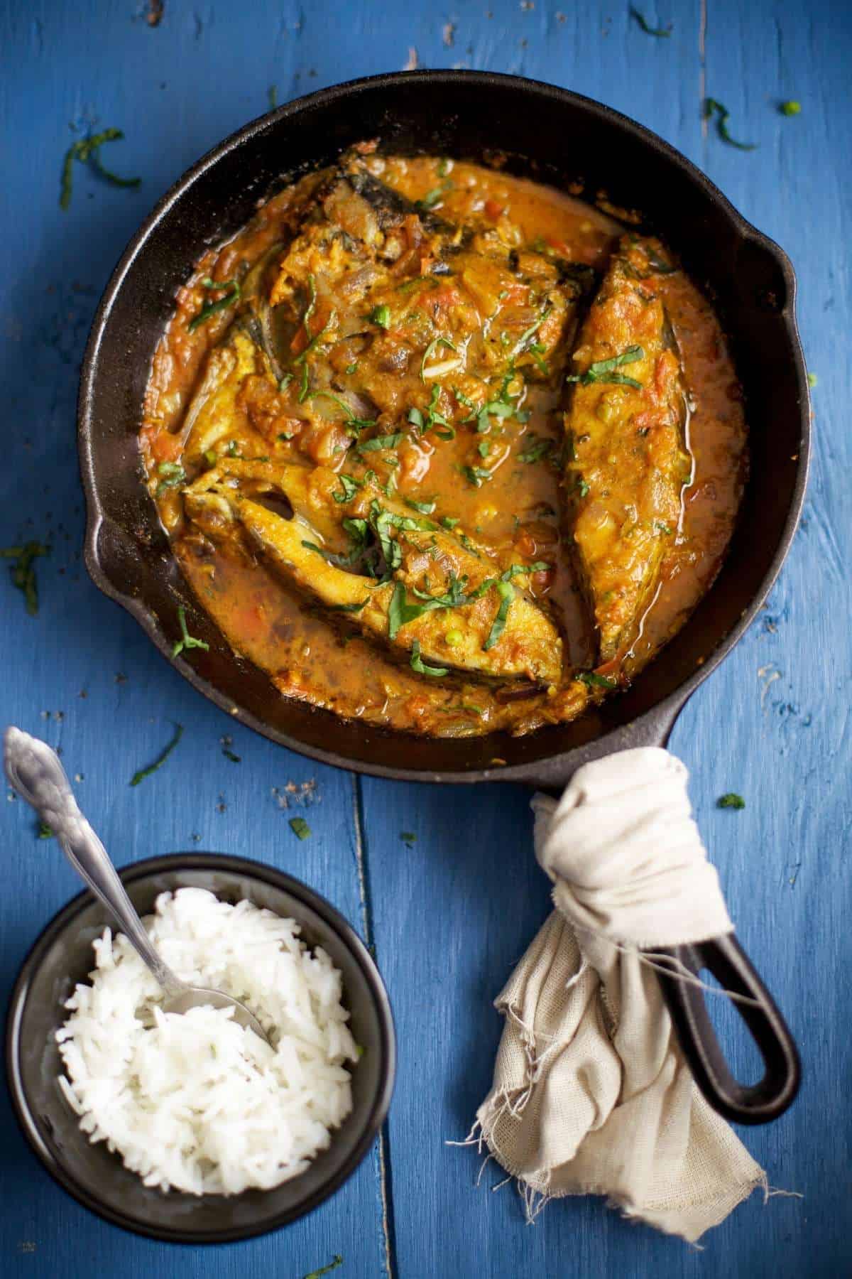 Punjabi Style Fish in a curried tomato onion sauce. Served in a cast iron pan. 