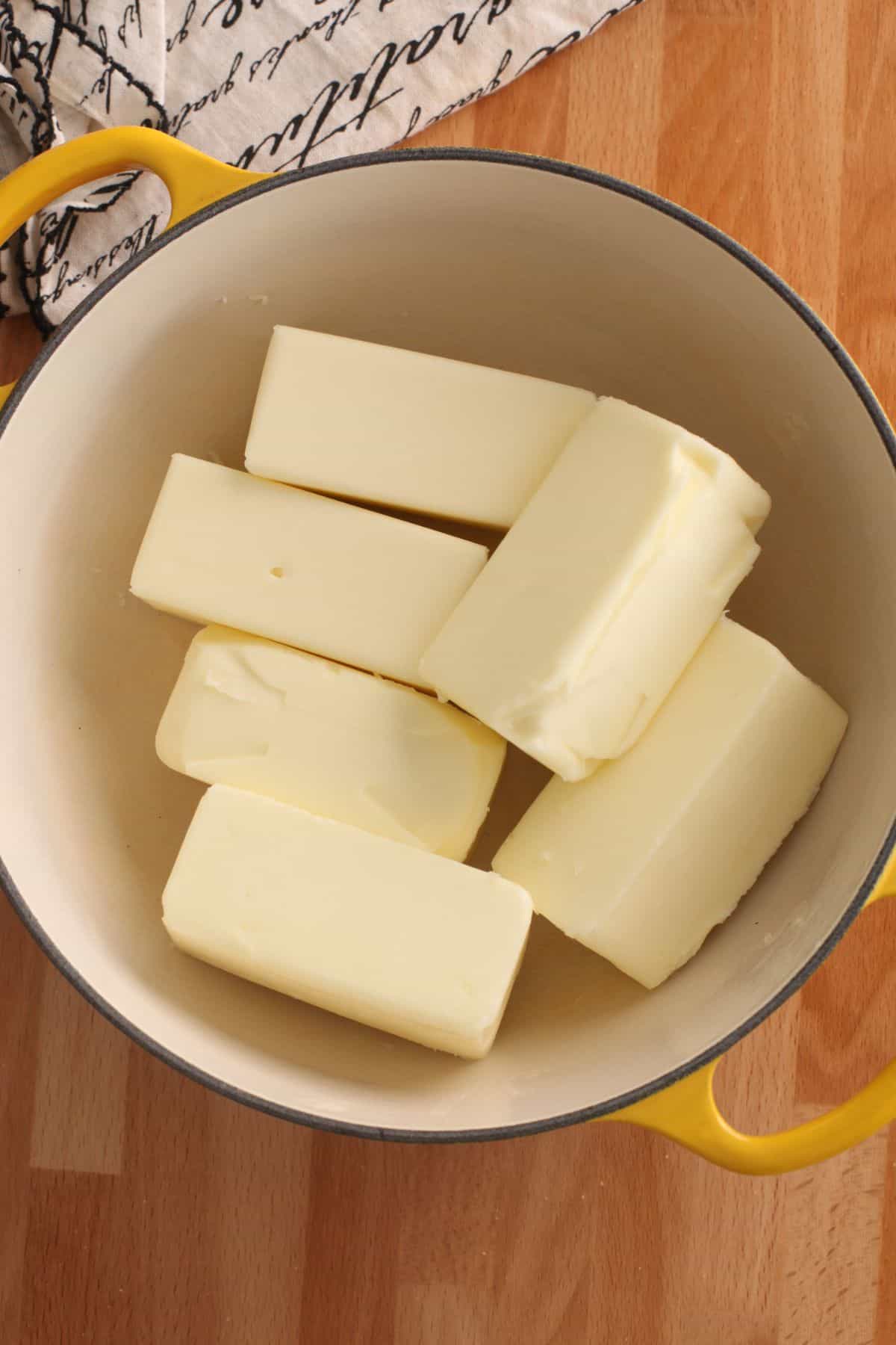 Unsalted butter sticks in a dutch oven.