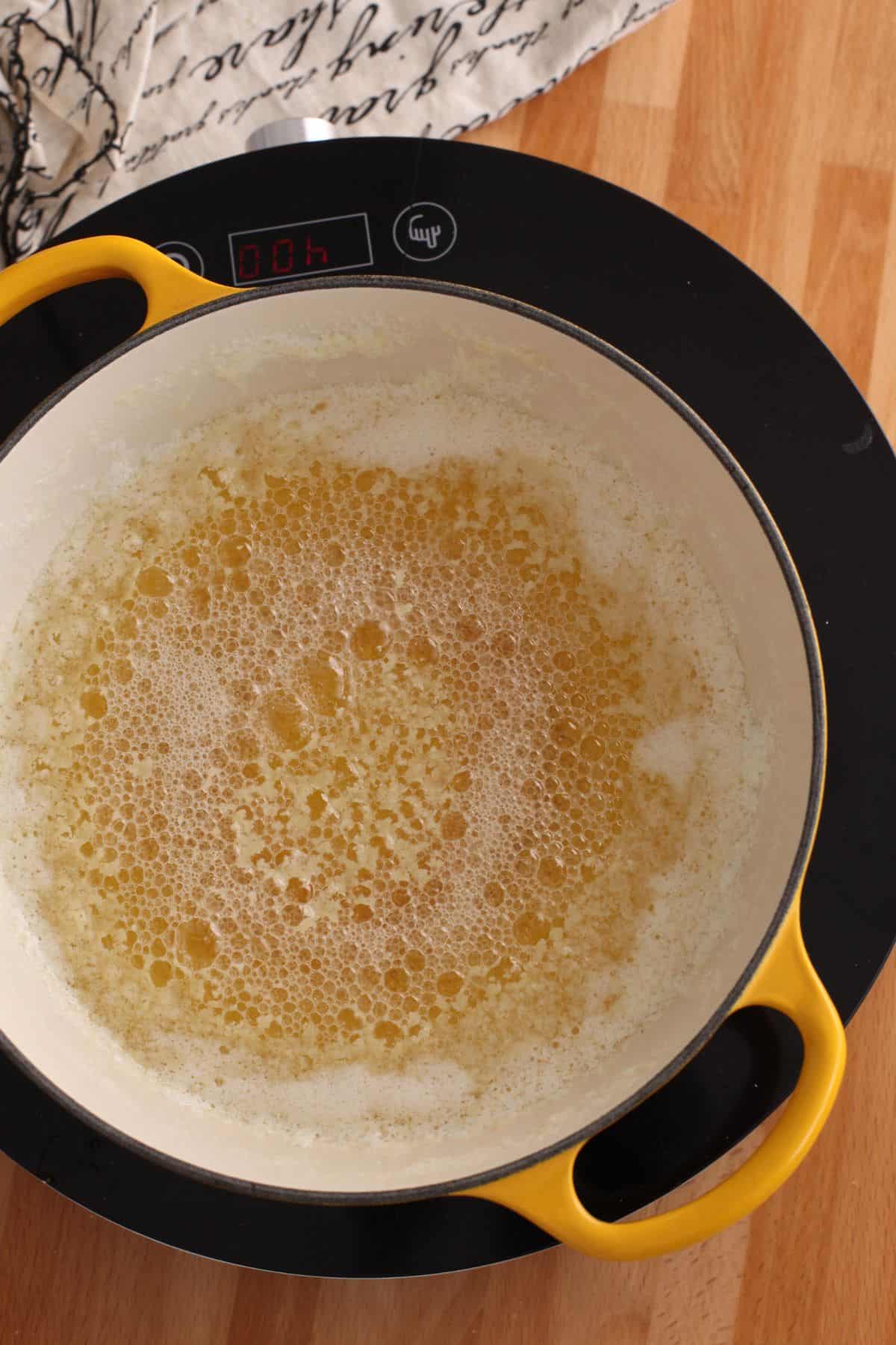 Butter crackling in a dutch oven while making ghee.