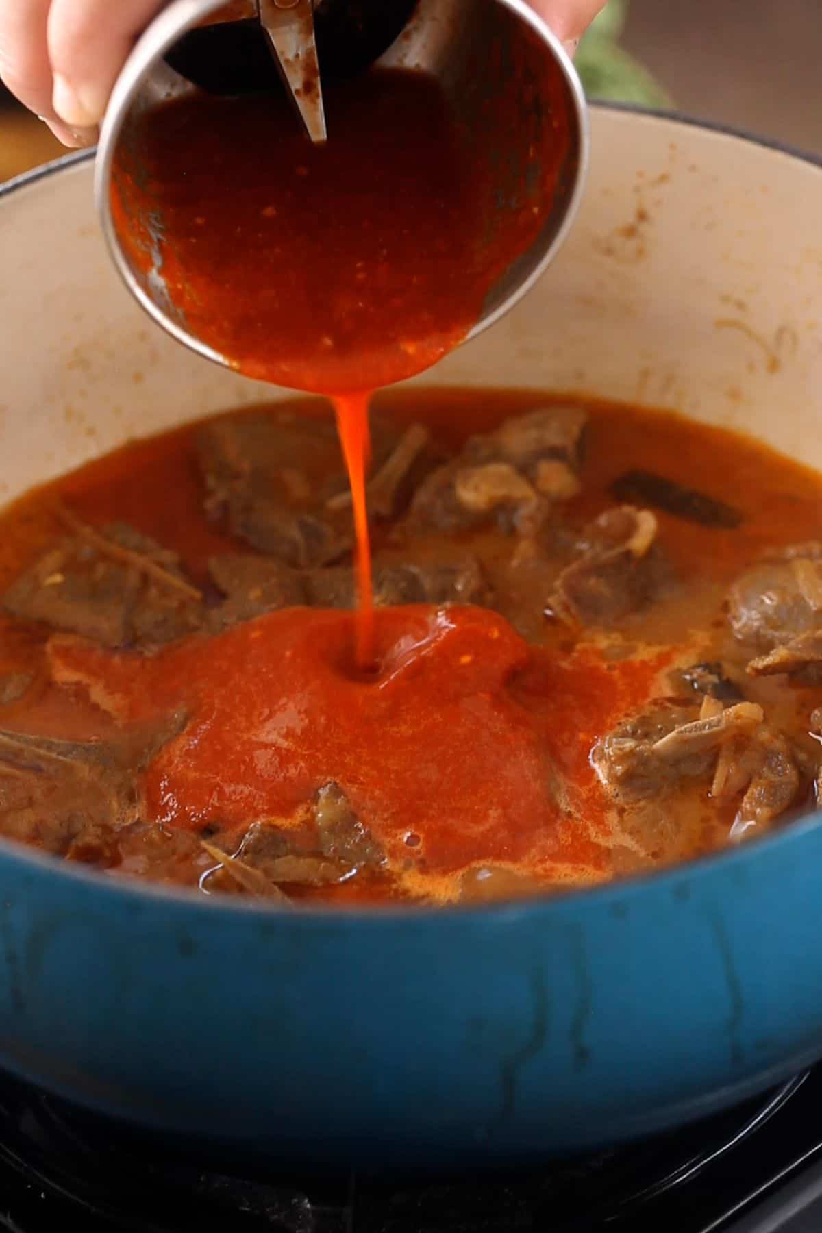 Gound red kashmiri chili paste is added to meat.