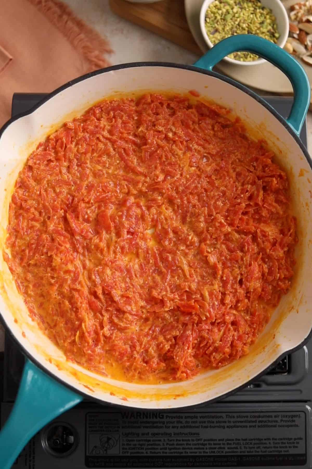 Milk has evaporated and the shredded carrots have fully softened.