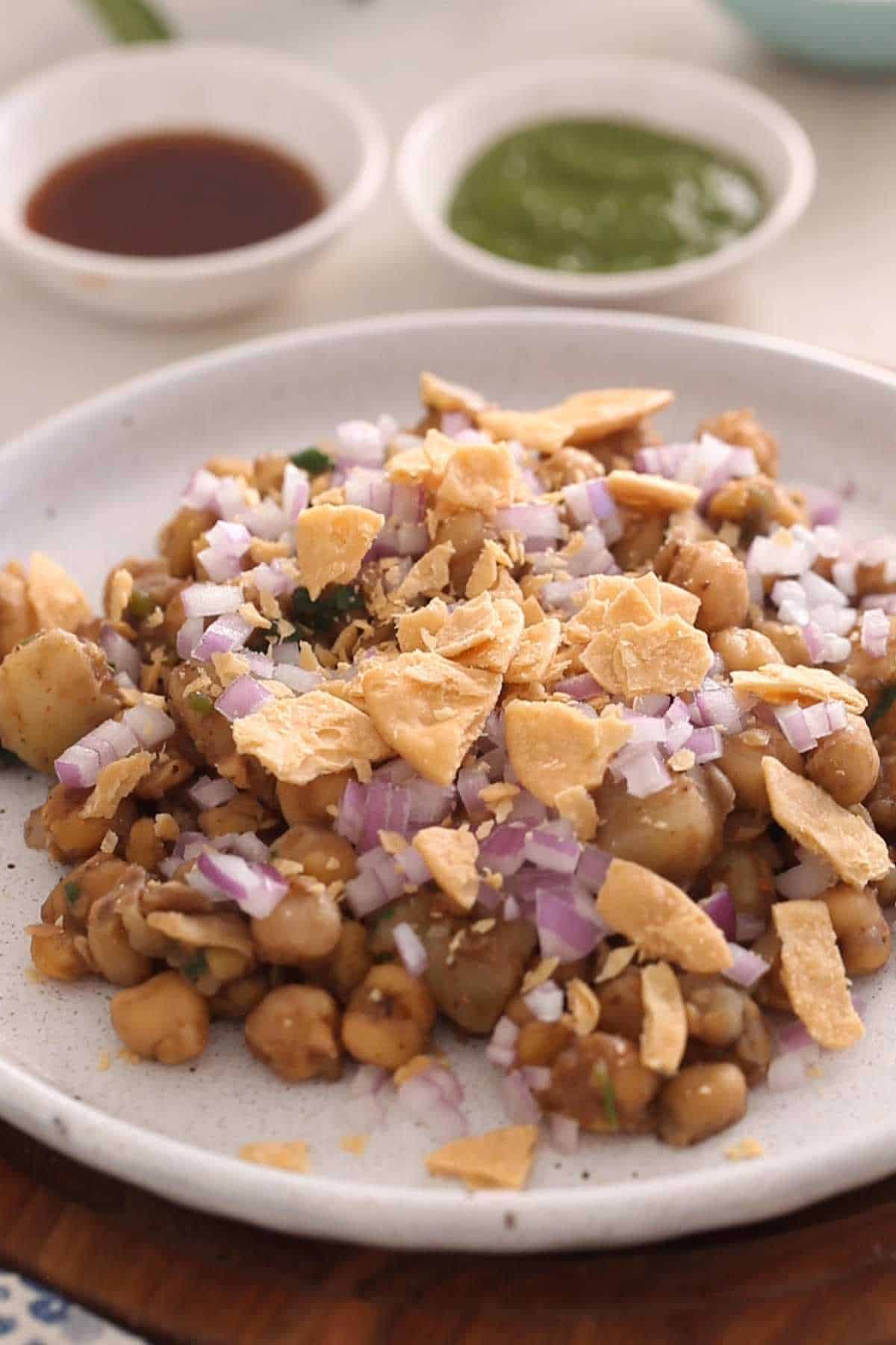 Chickpeas and potatoes mixture topped with sev and crushed papdi.