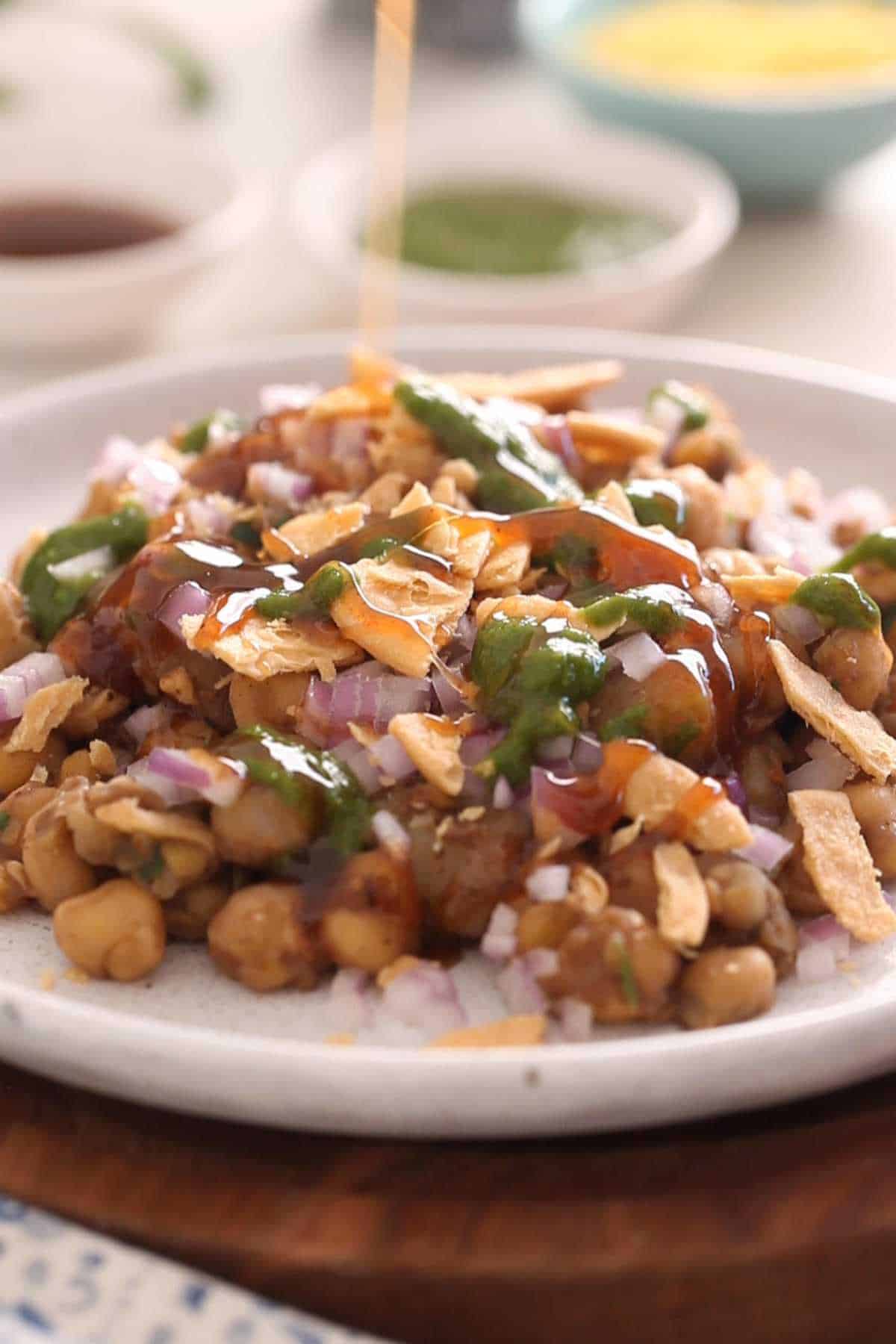 Drizzle chutneys on chana chaat.