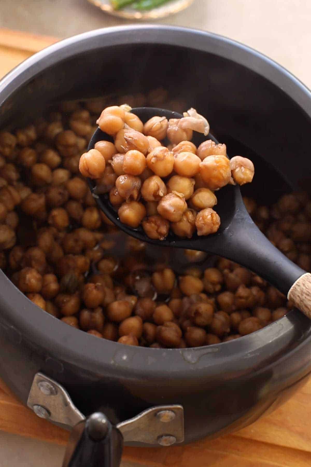 Boiled, soft & tender chickpeas after pressure cooking.