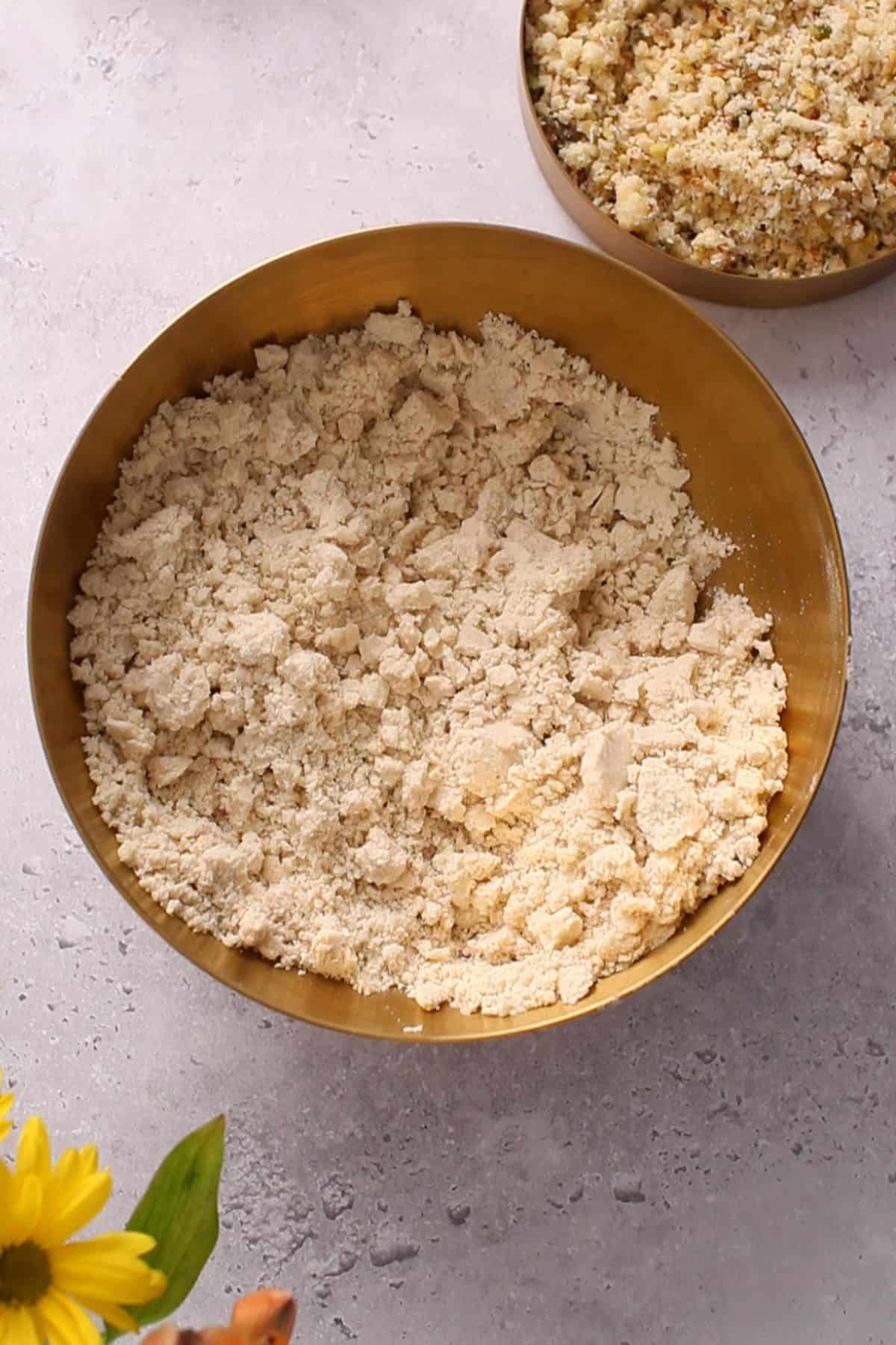 After incorporating ghee, flour resembles sand.