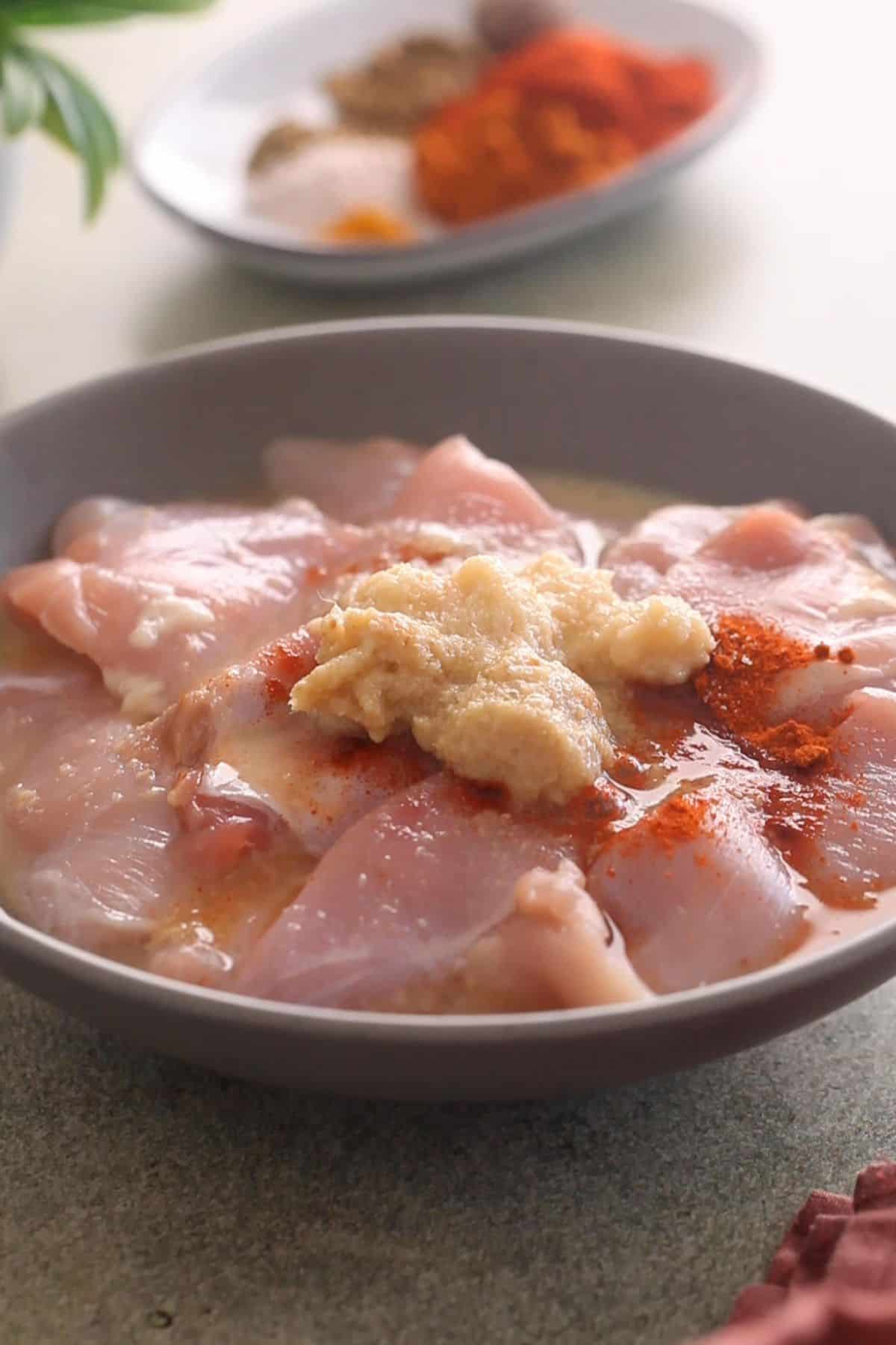 Ingredients for first marination are added to chicken.