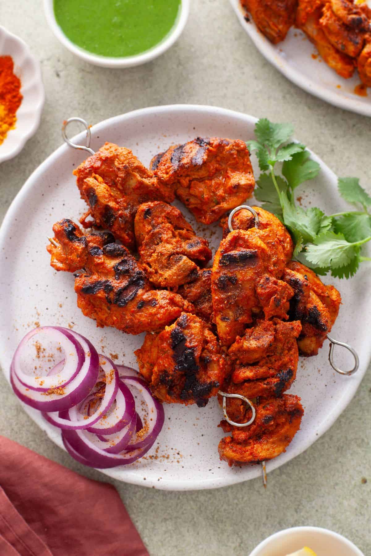 Close up of tandoori Chicken Tikka served on a white plate.