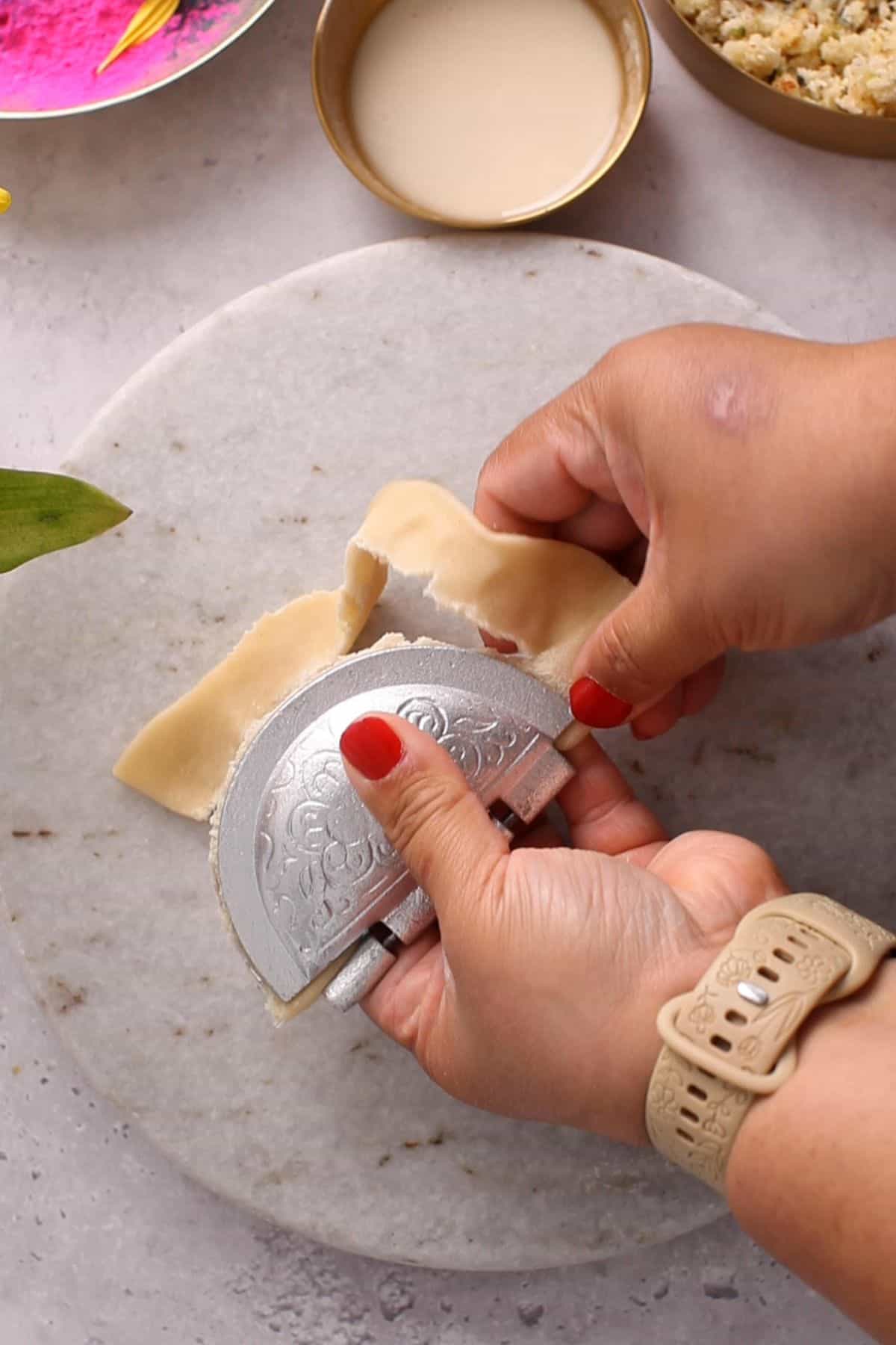 Excess dough is removed from the sides of the mould.