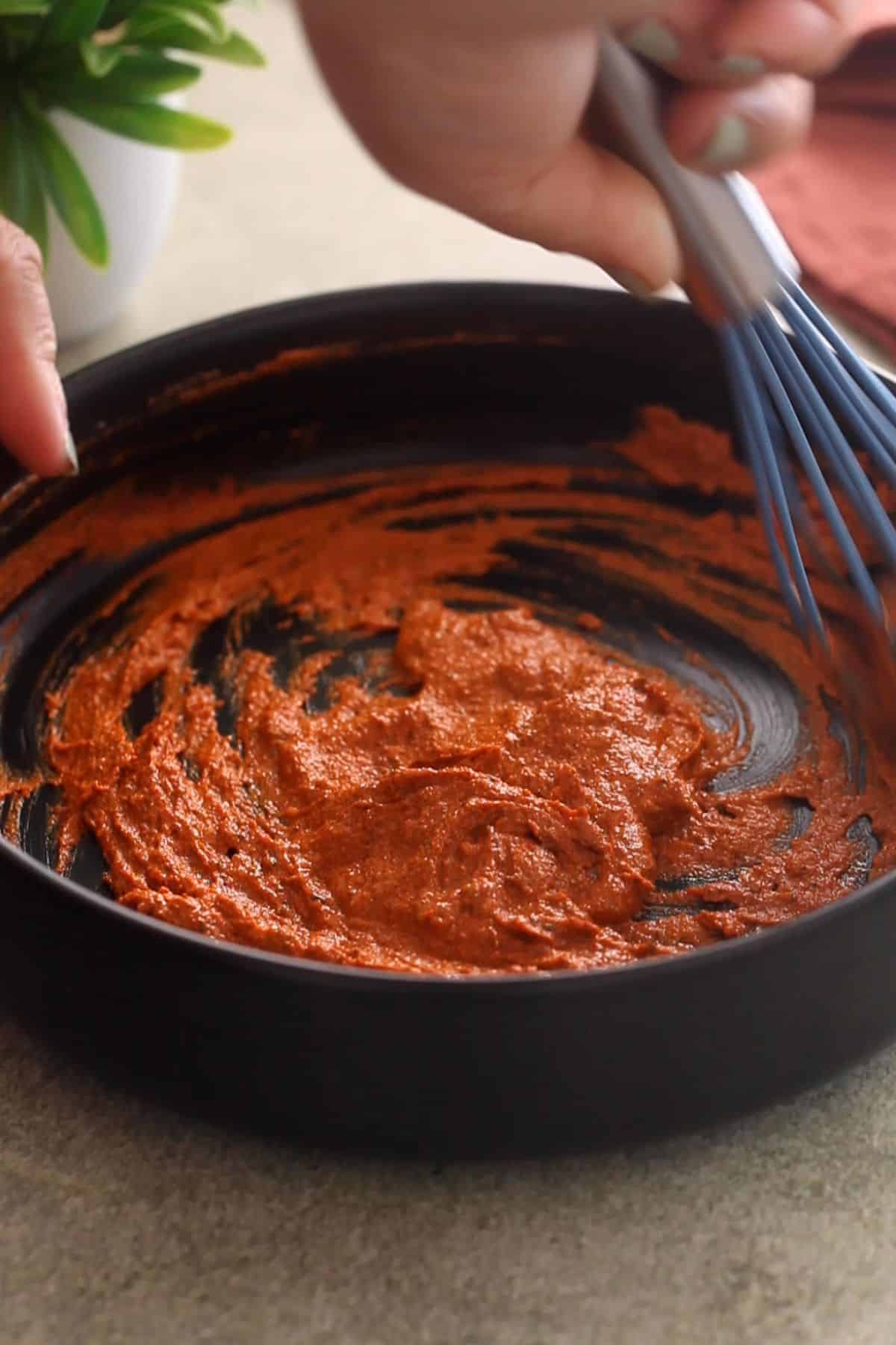 Whisking tthe tandoori marinade to make it smooth.