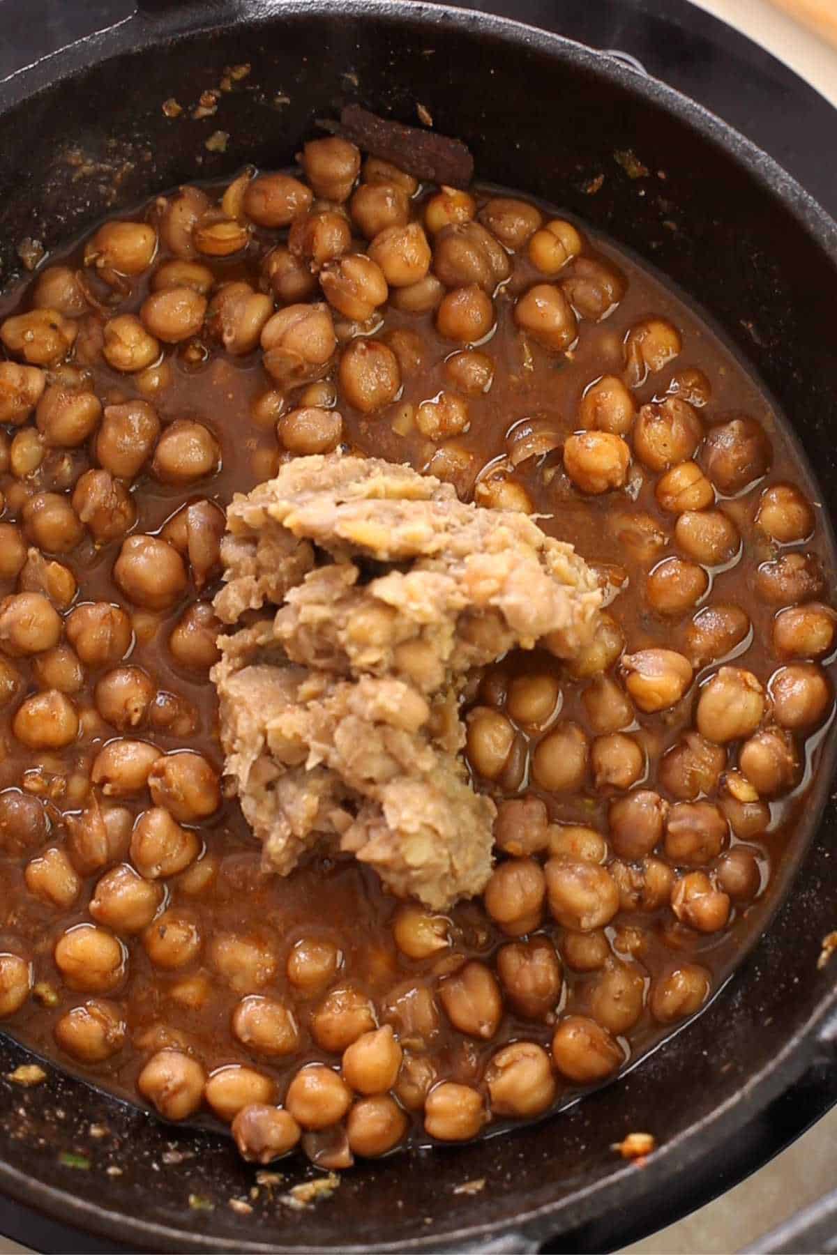Mashed chickpeas added to pindi chole.