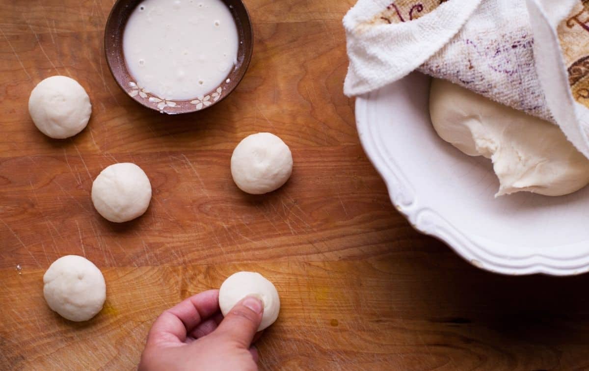 Dough portioned and rolled into balls for Making Chashni Gujiya 
