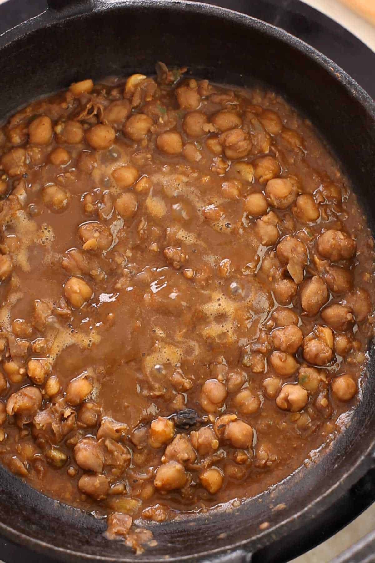 Pindi chana simmering in a cast iron pot.