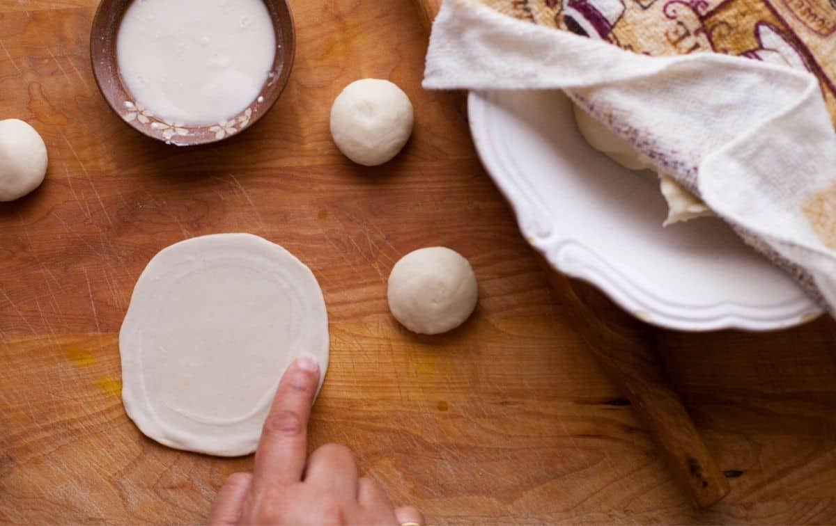 Flour paste being applied to rolled dough
