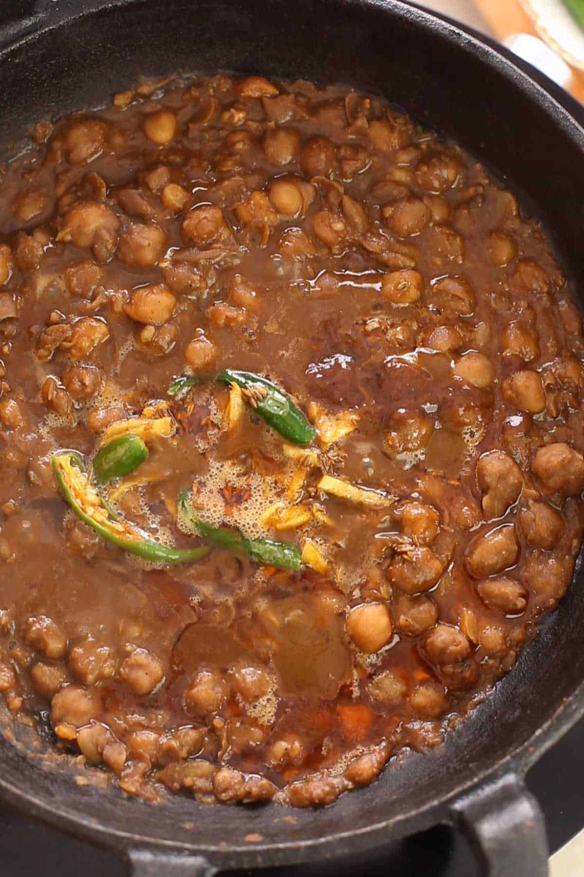 Tempering and tamarind is added to pinchi chana.