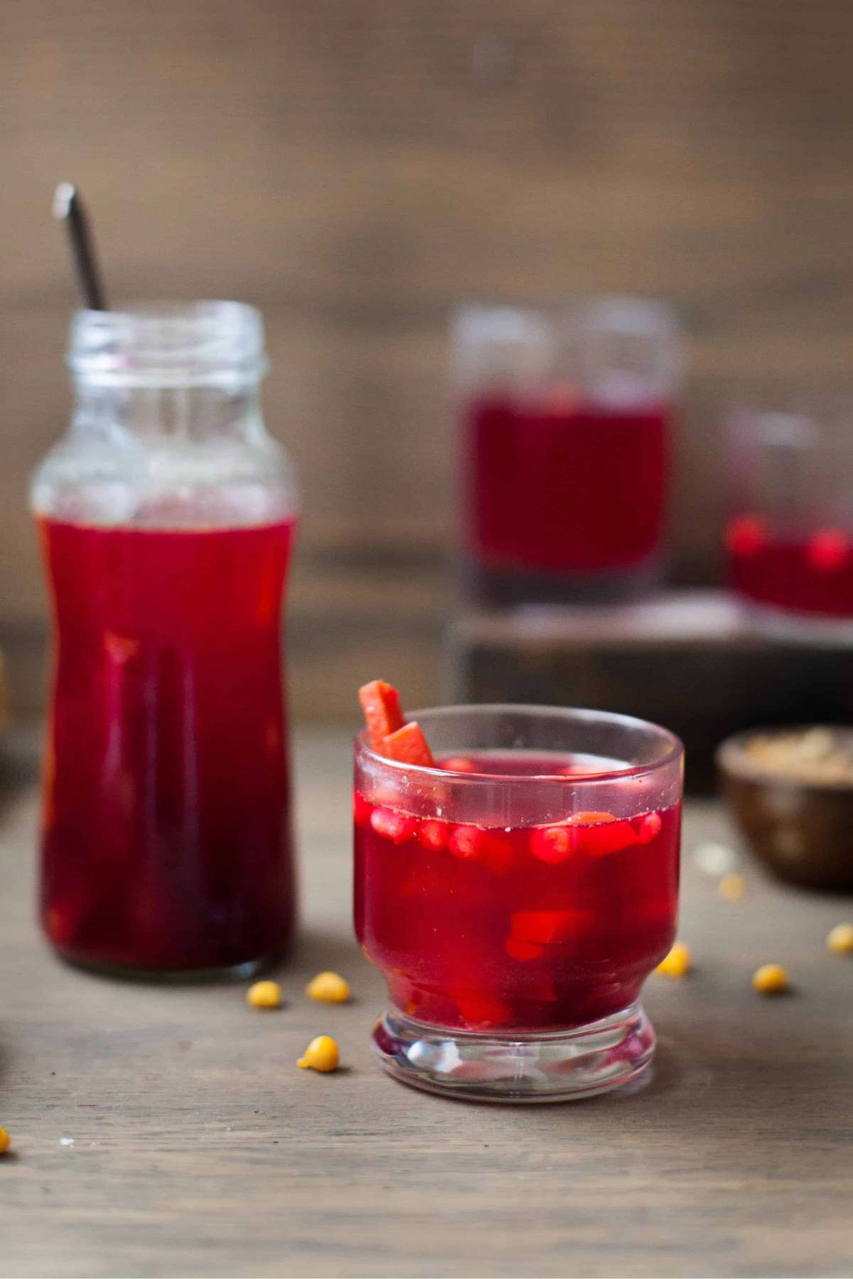 Kanji Drink in a bottle and small cup topped with gram flour balls.