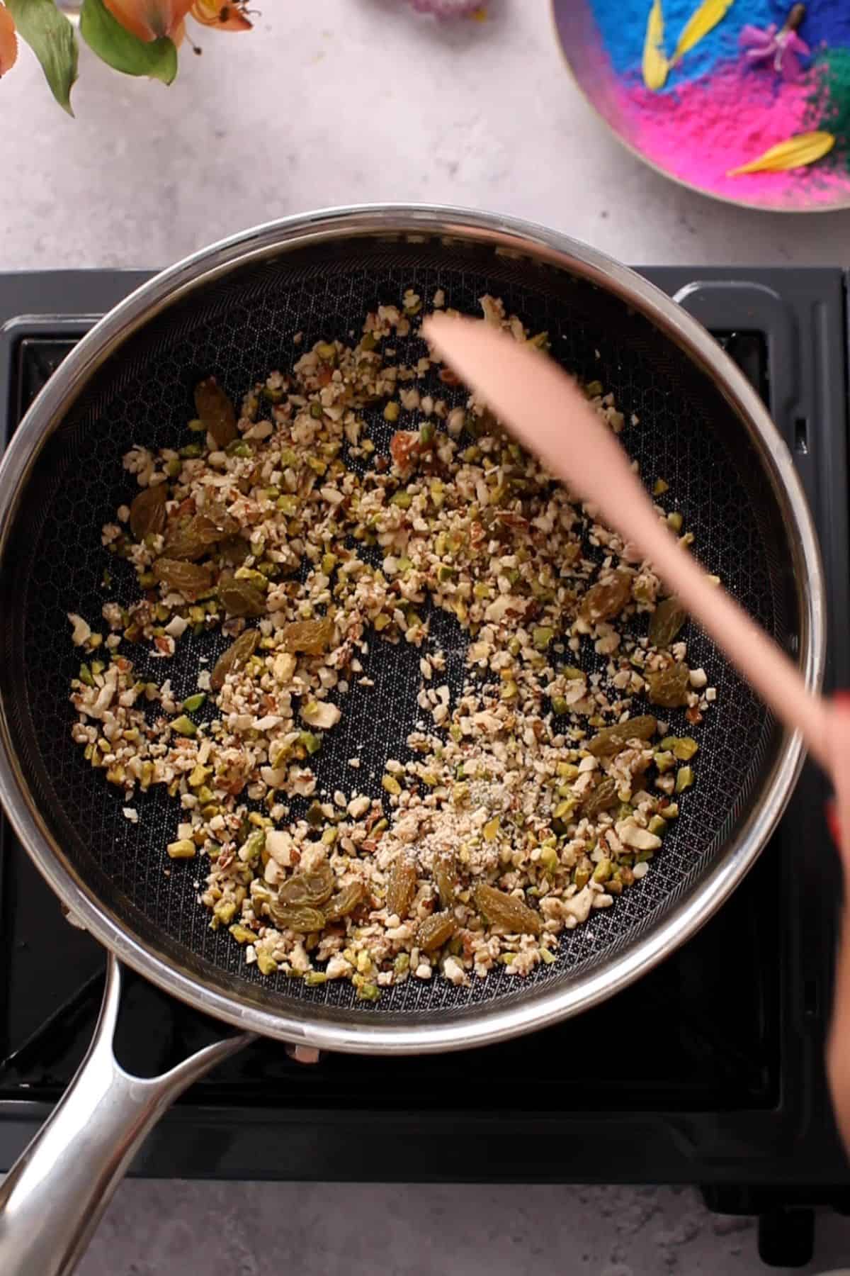 Chopped nuts roasting in ghee.