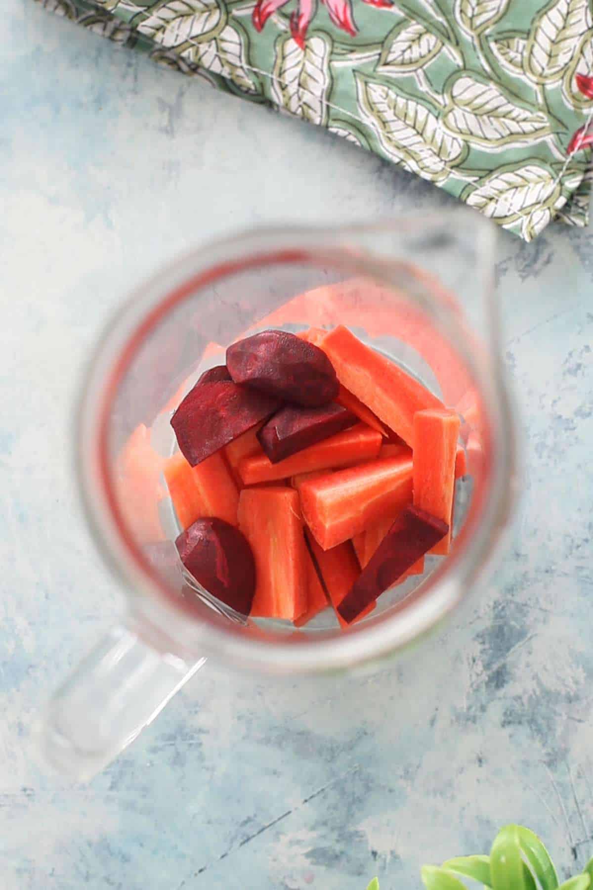 Carrot & Beetroot sticks placed in a tall glass jar.