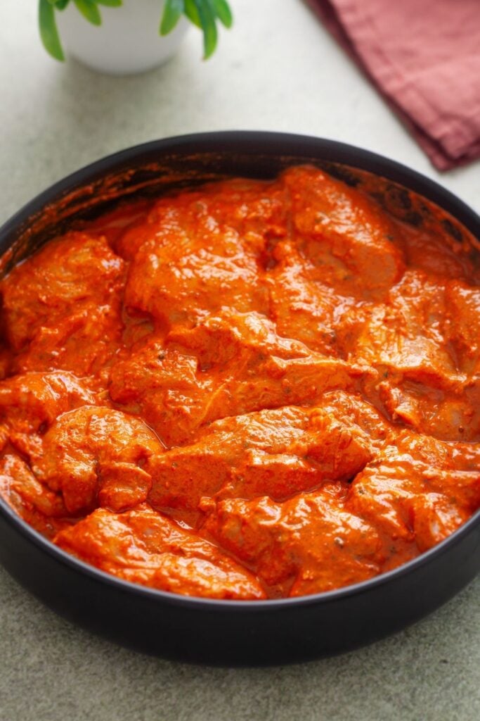 Chicken pieces coated in tandoori marinade.