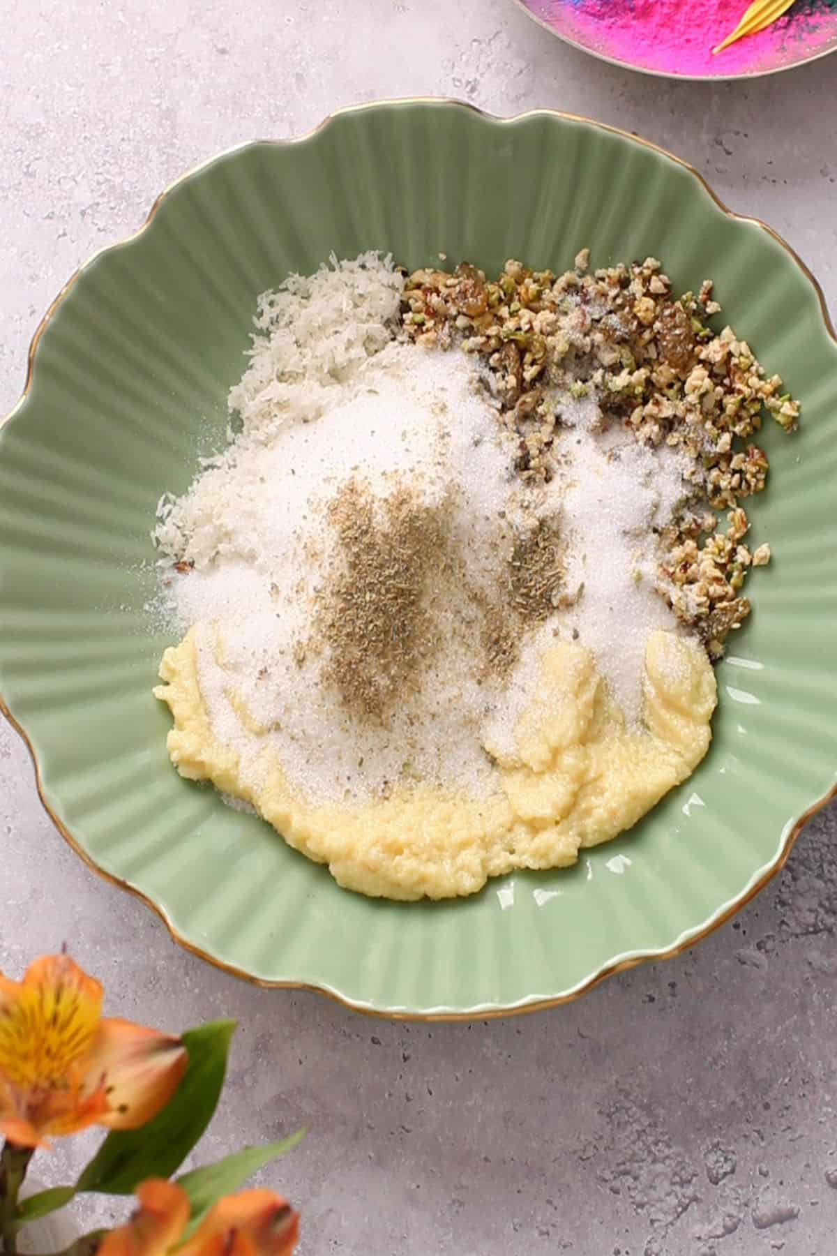 Ingredients of gujiya filling in a green bowl.