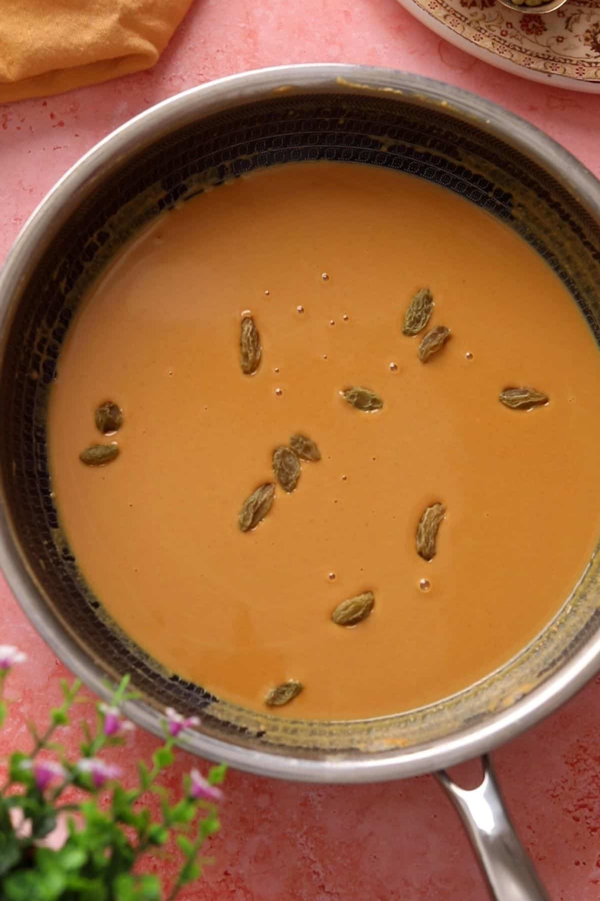 Golden raisins are added to the roasted besan.