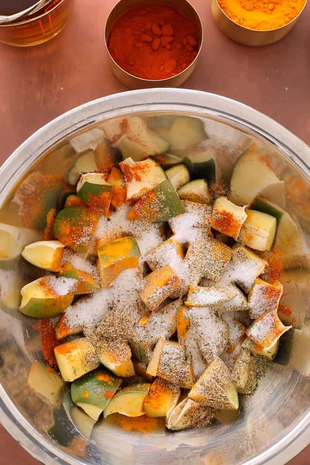 Raw mango pieces sprinkled with ground spices and salt.