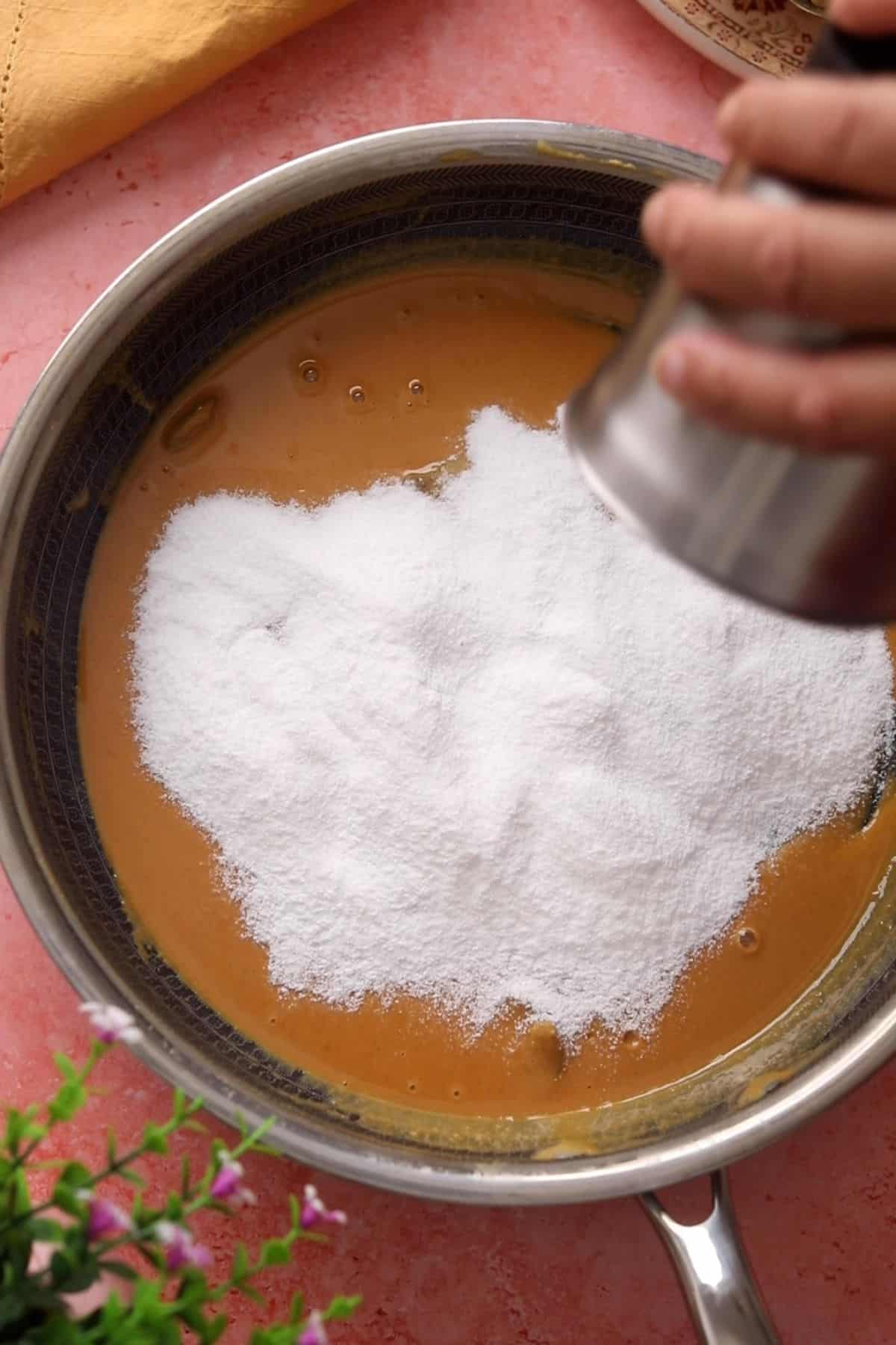 Sugar is added to the besan mixture.