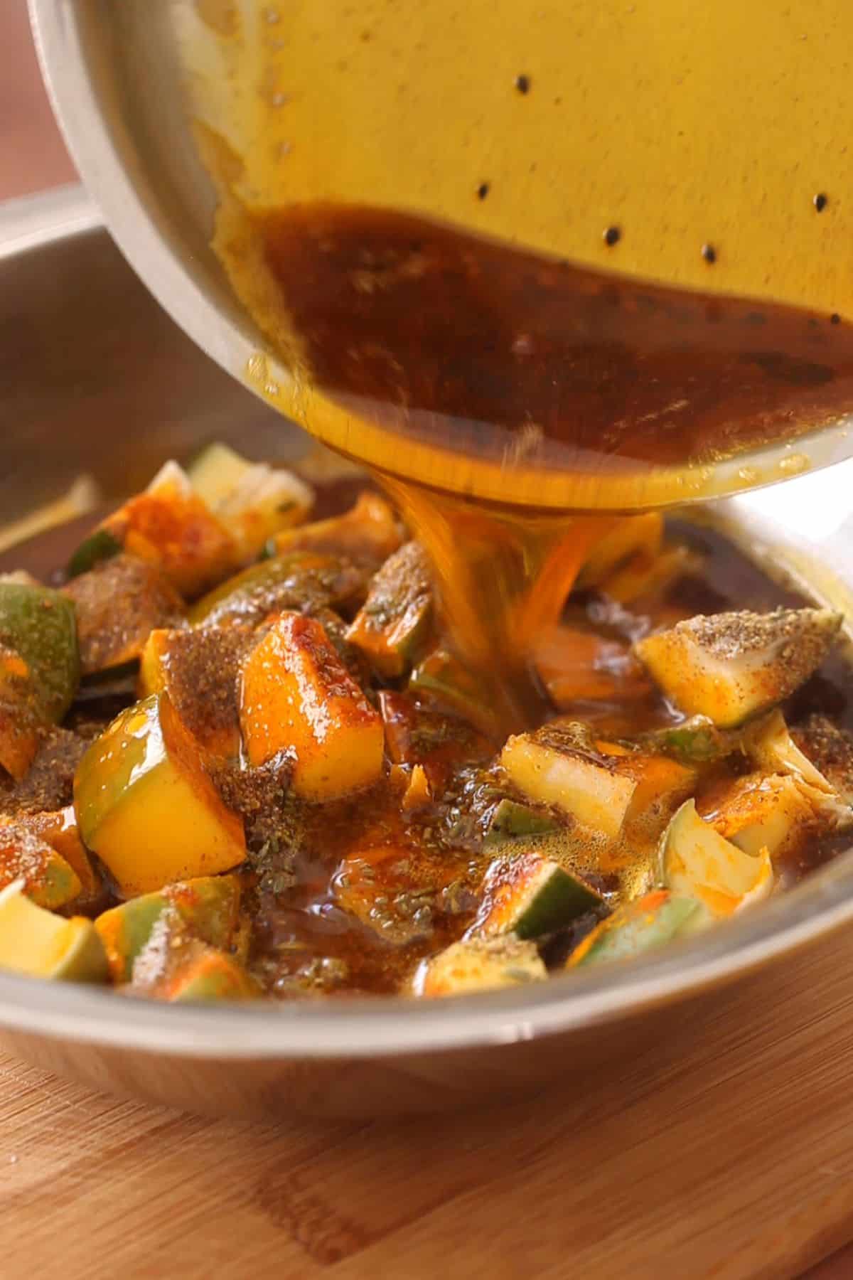 Warm oil is poured over mango pieces. 