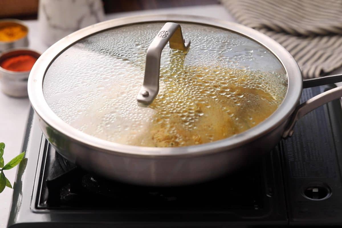 Pan is covered with lid and left to simmer.