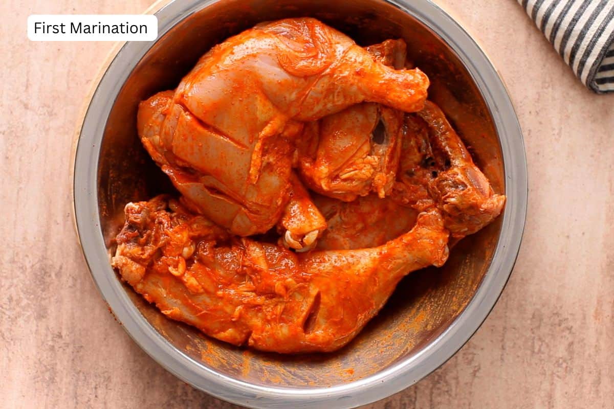 Chicken is first marinated in lemon juice, salt and kashmiri red chili powder.