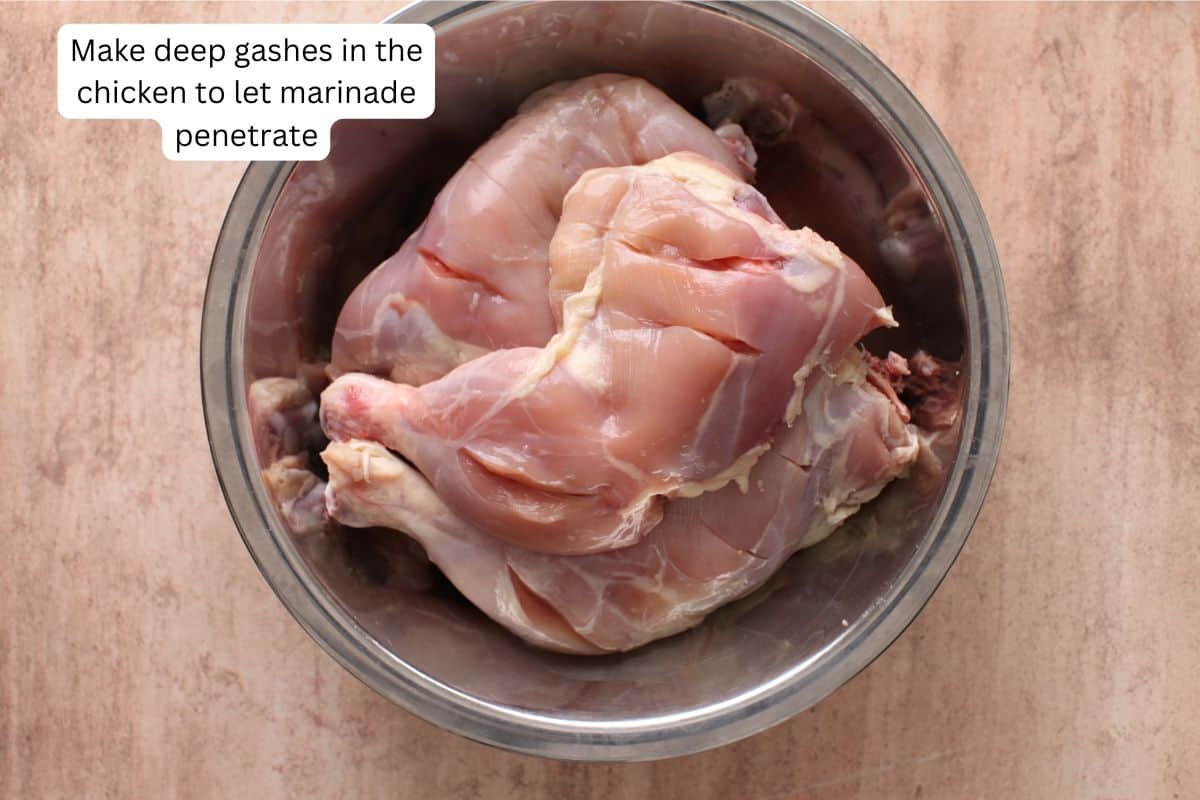 Image showing the deep cuts made in tandoori chicken. 