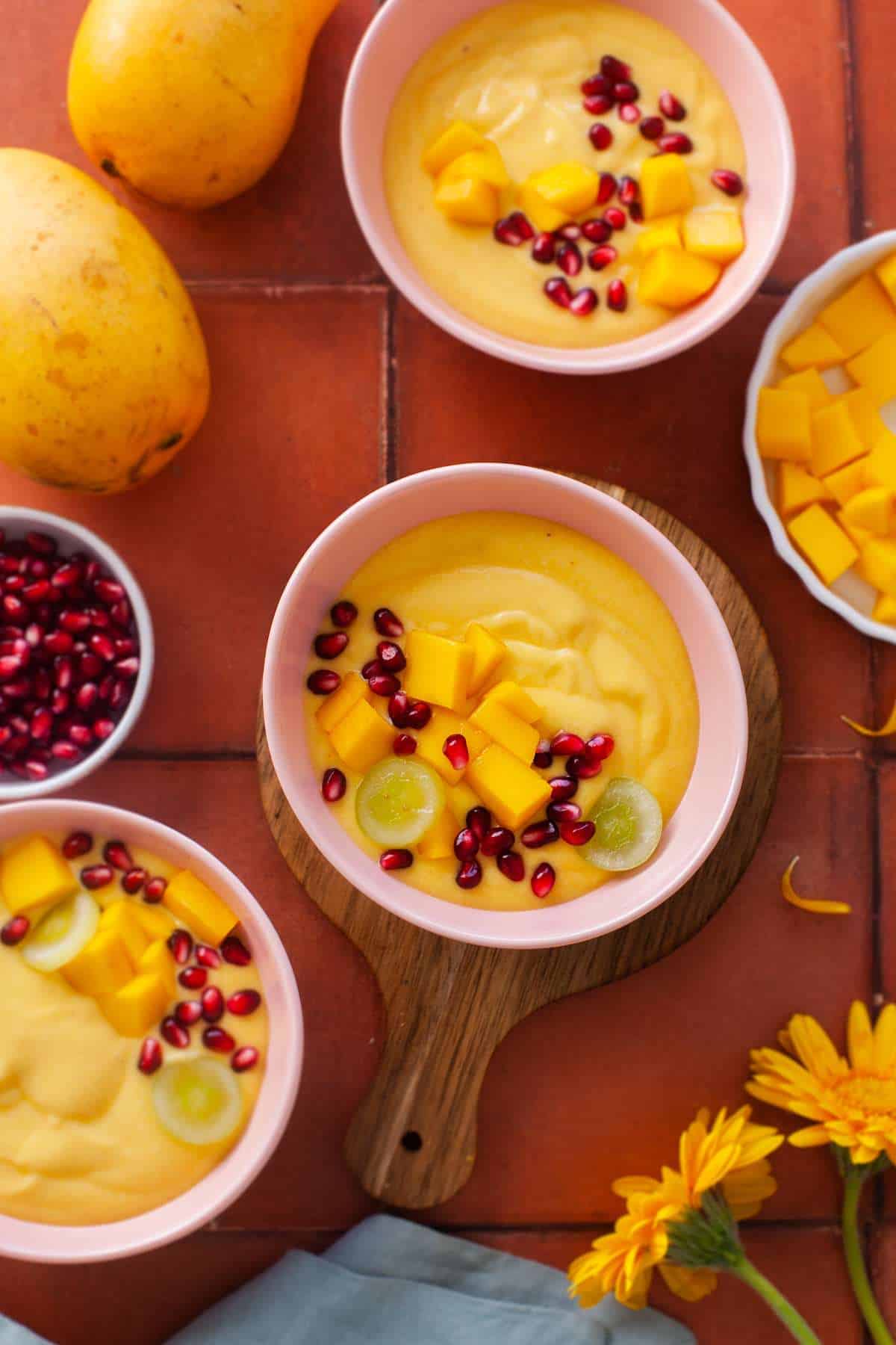 Mango Custard bowls placed on a a terra-cotta background.