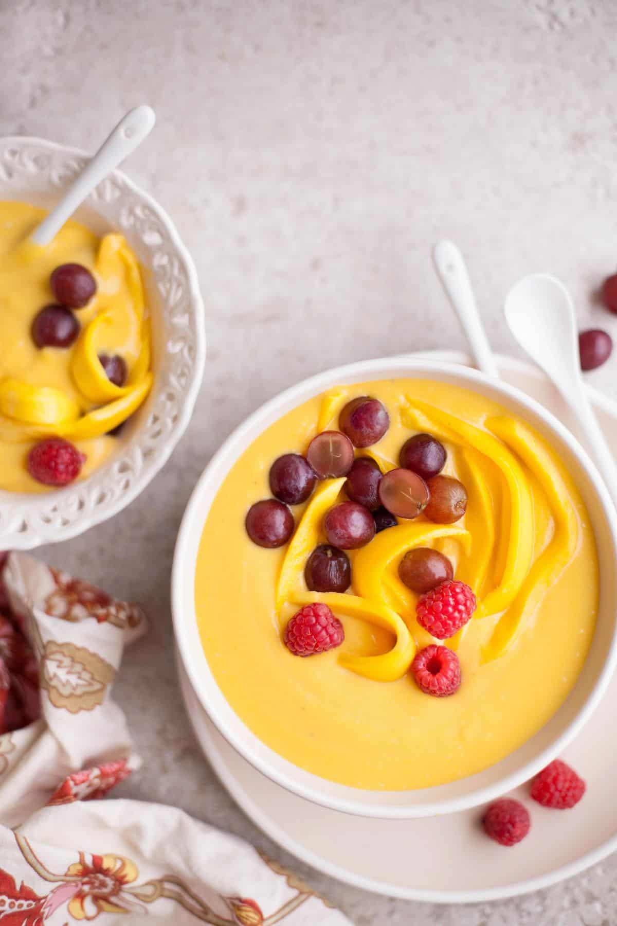 Indian fruit custard in a white bowl with fresh fruits