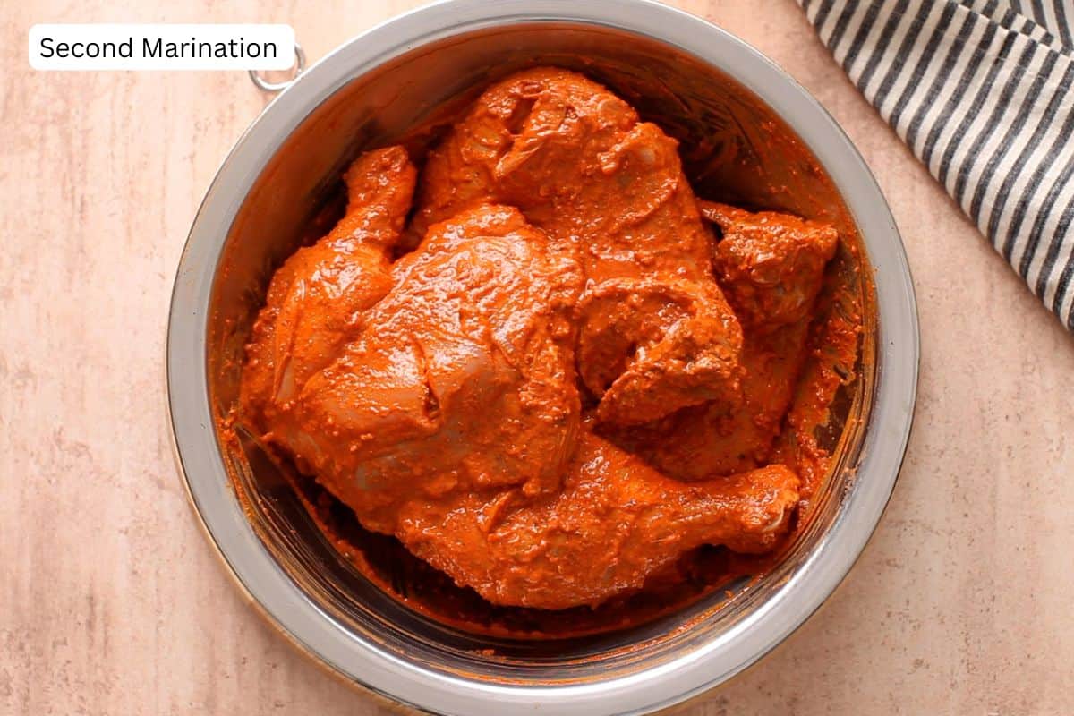 Tandoori marinade is added to chicken. 